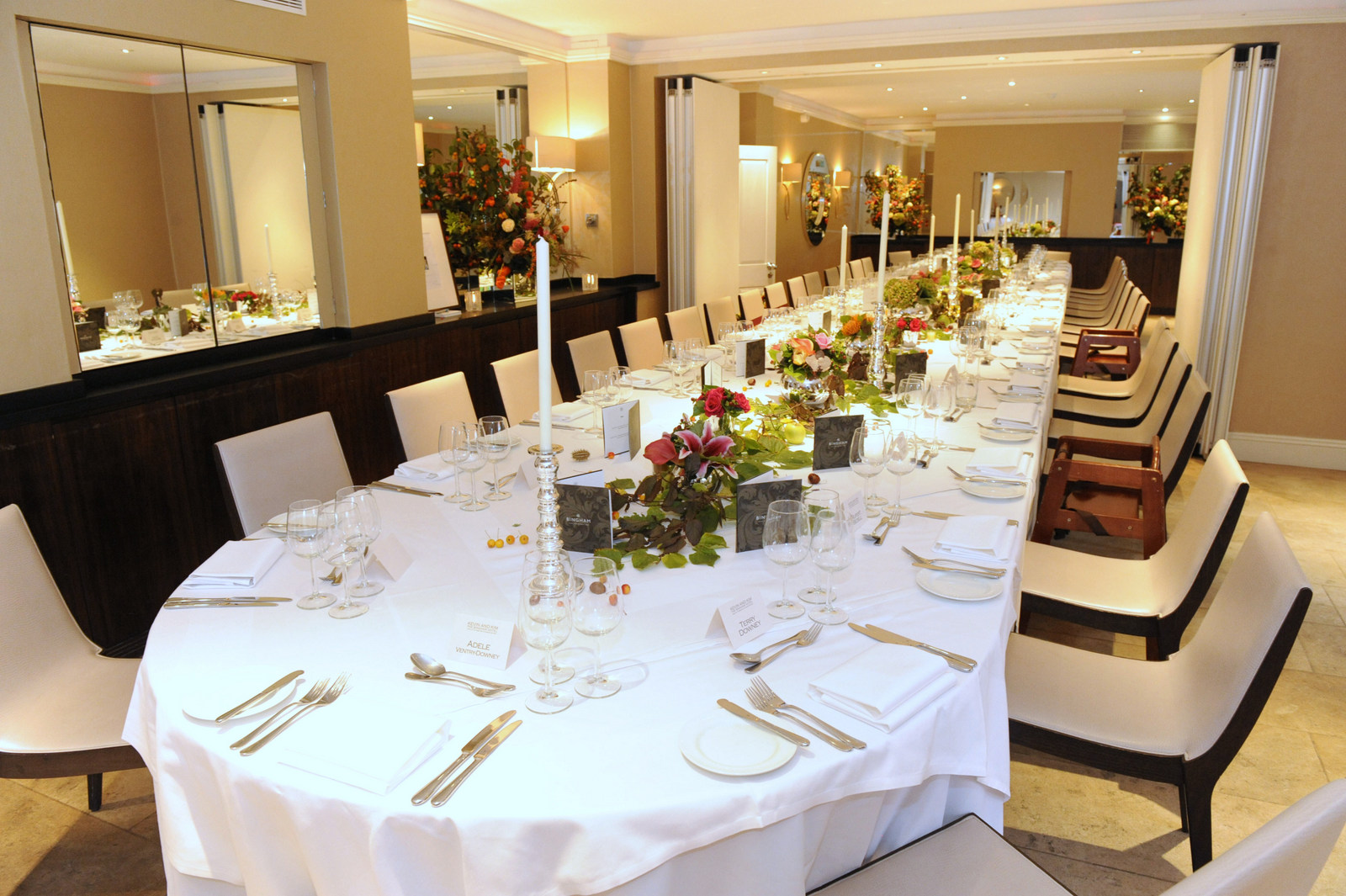 Elegant dining setup with floral centerpieces for formal dinners and corporate events.