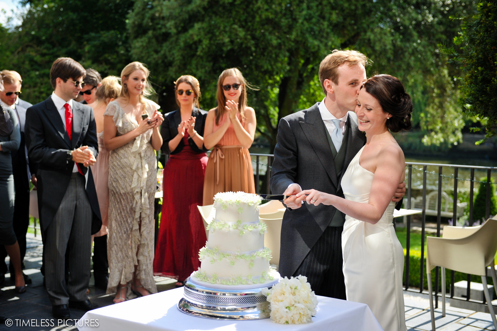 Wedding reception at The Bingham's Terrace & Garden with elegant cake-cutting moment.