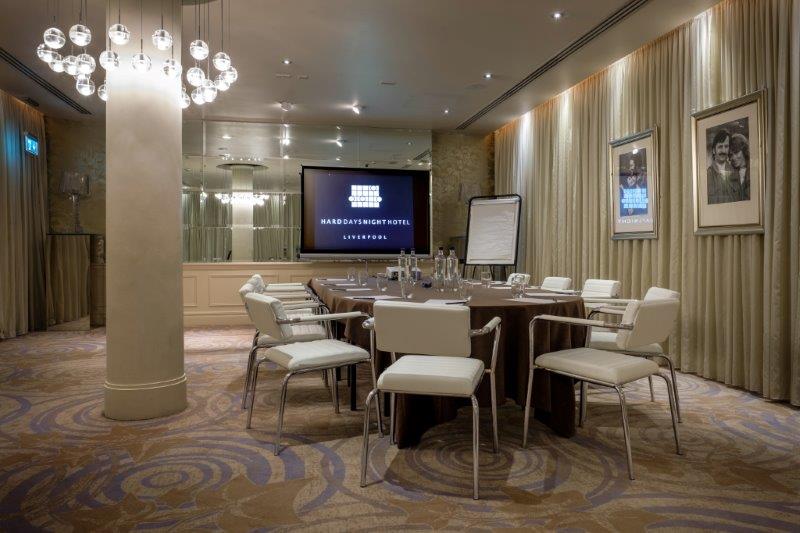 Meeting room with central table and modern chairs at Hard Days Night Hotel.