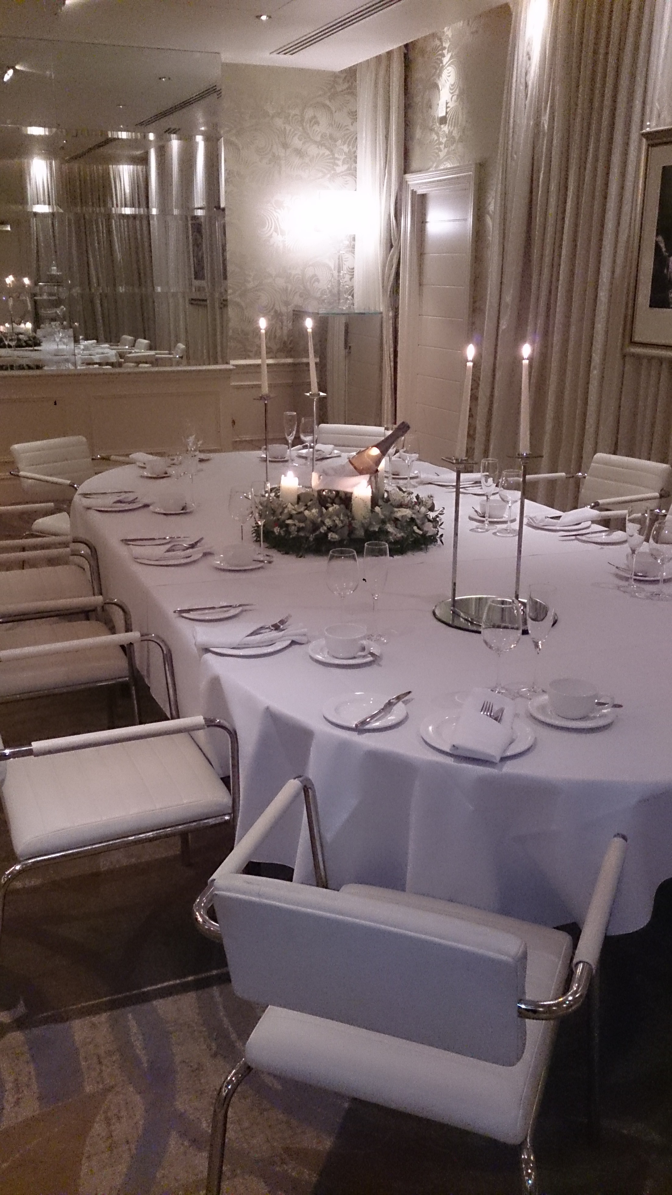 Elegant round table setting with floral centerpiece at Hard Days Night Hotel event.