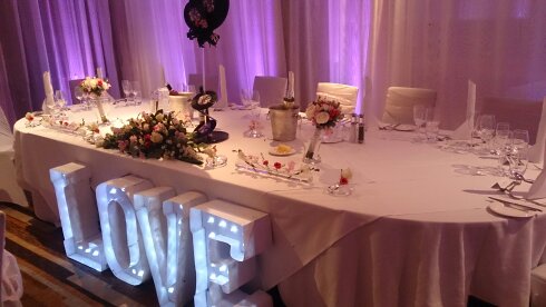 Zygmant Suite with romantic table setting and "LOVE" sign for weddings and gatherings.