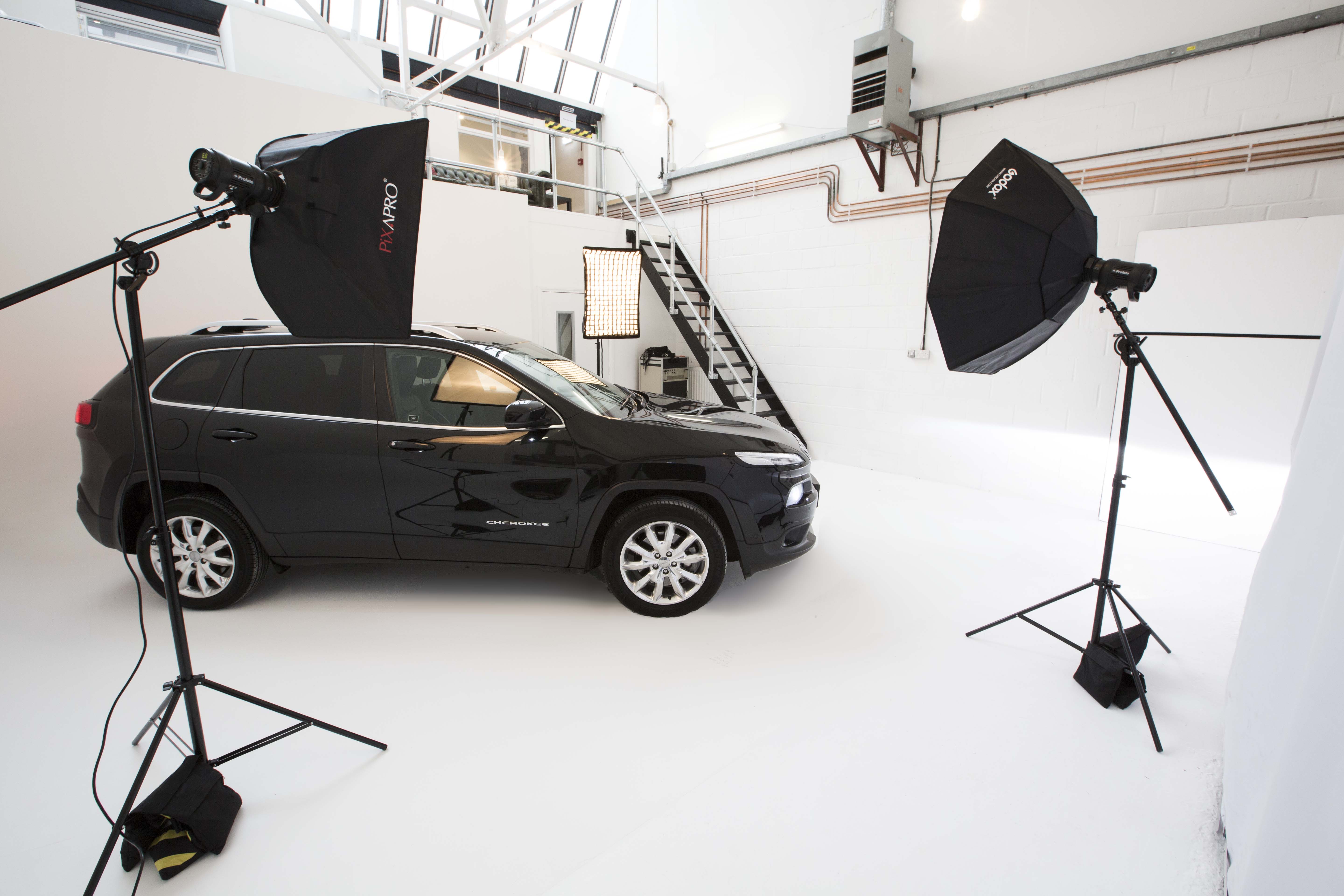 Sleek vehicle in well-lit studio for automotive product launch and promotional events.