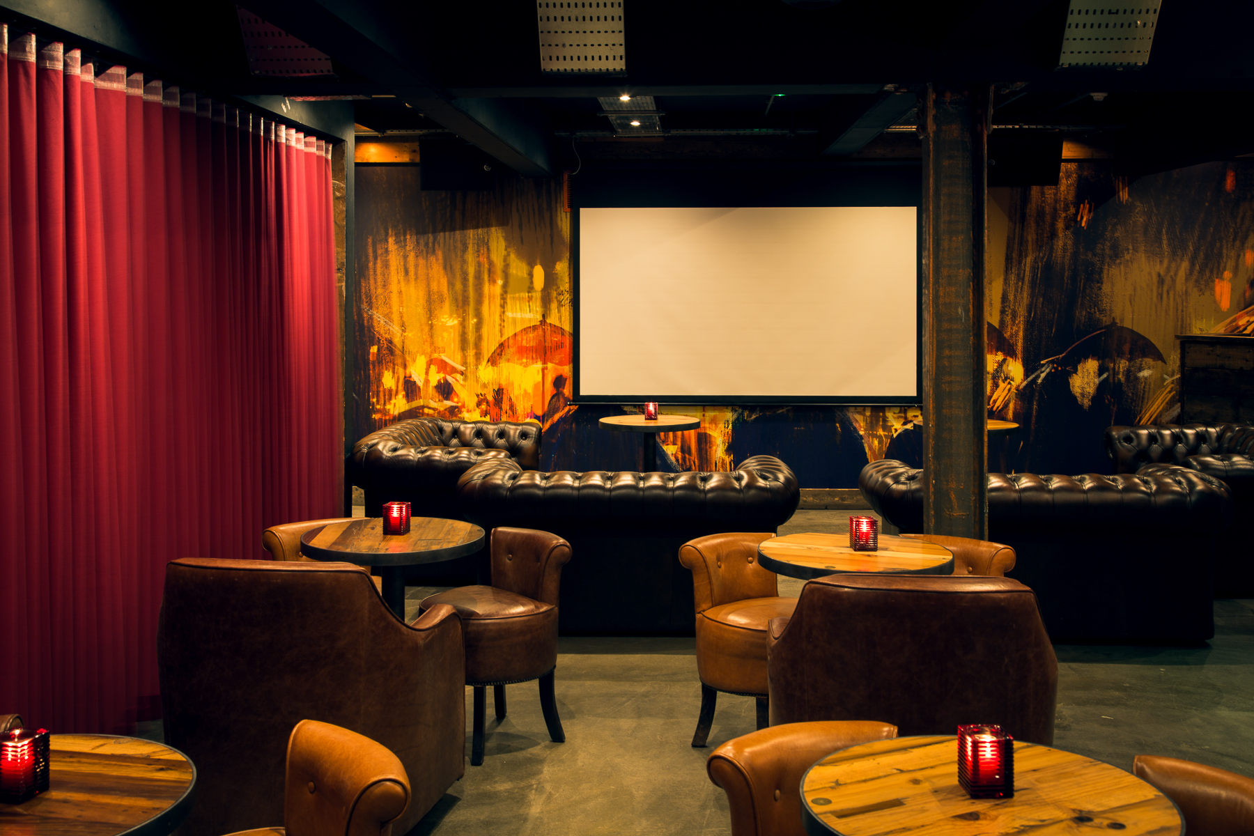 Stylish event space in Dive NQ with leather chairs, ideal for networking and gatherings.