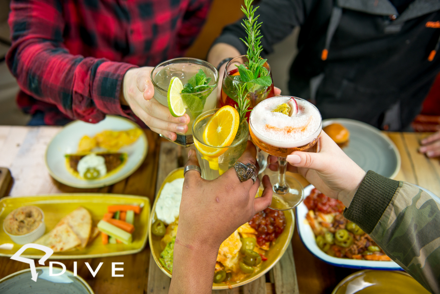 Vibrant networking event at Dive NQ with colorful drinks and casual dining.