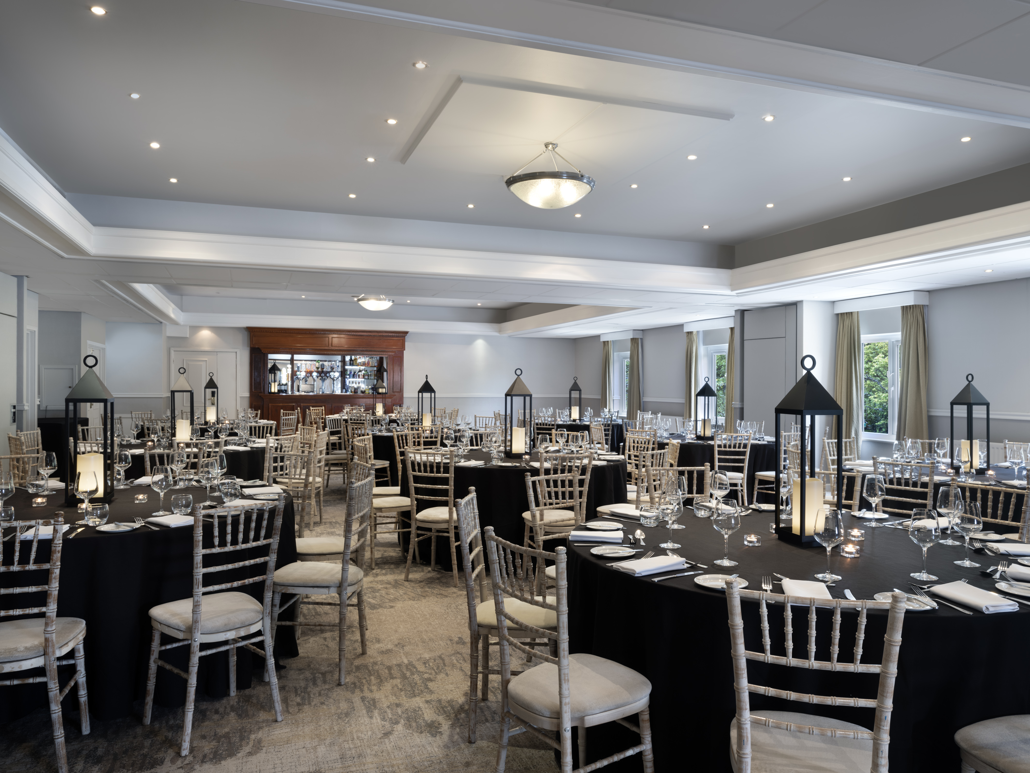 Elegant Thurnham Suite with black-draped tables, perfect for weddings or corporate events.