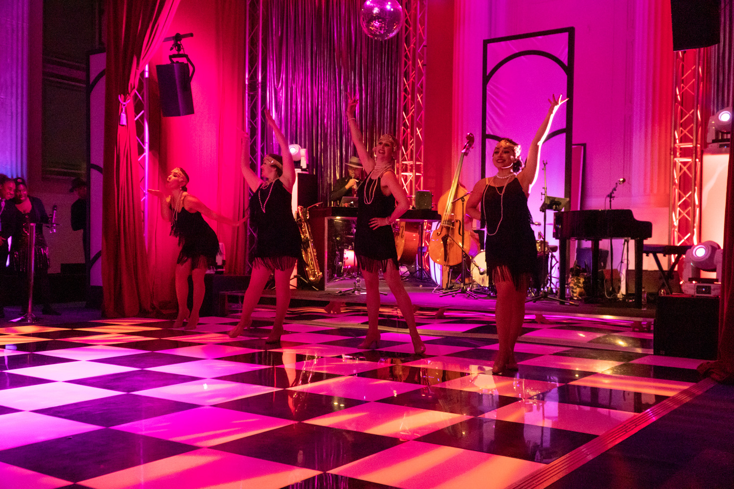 "Christmas party dance performance at Freemasons' Hall with vibrant decor and ambiance."