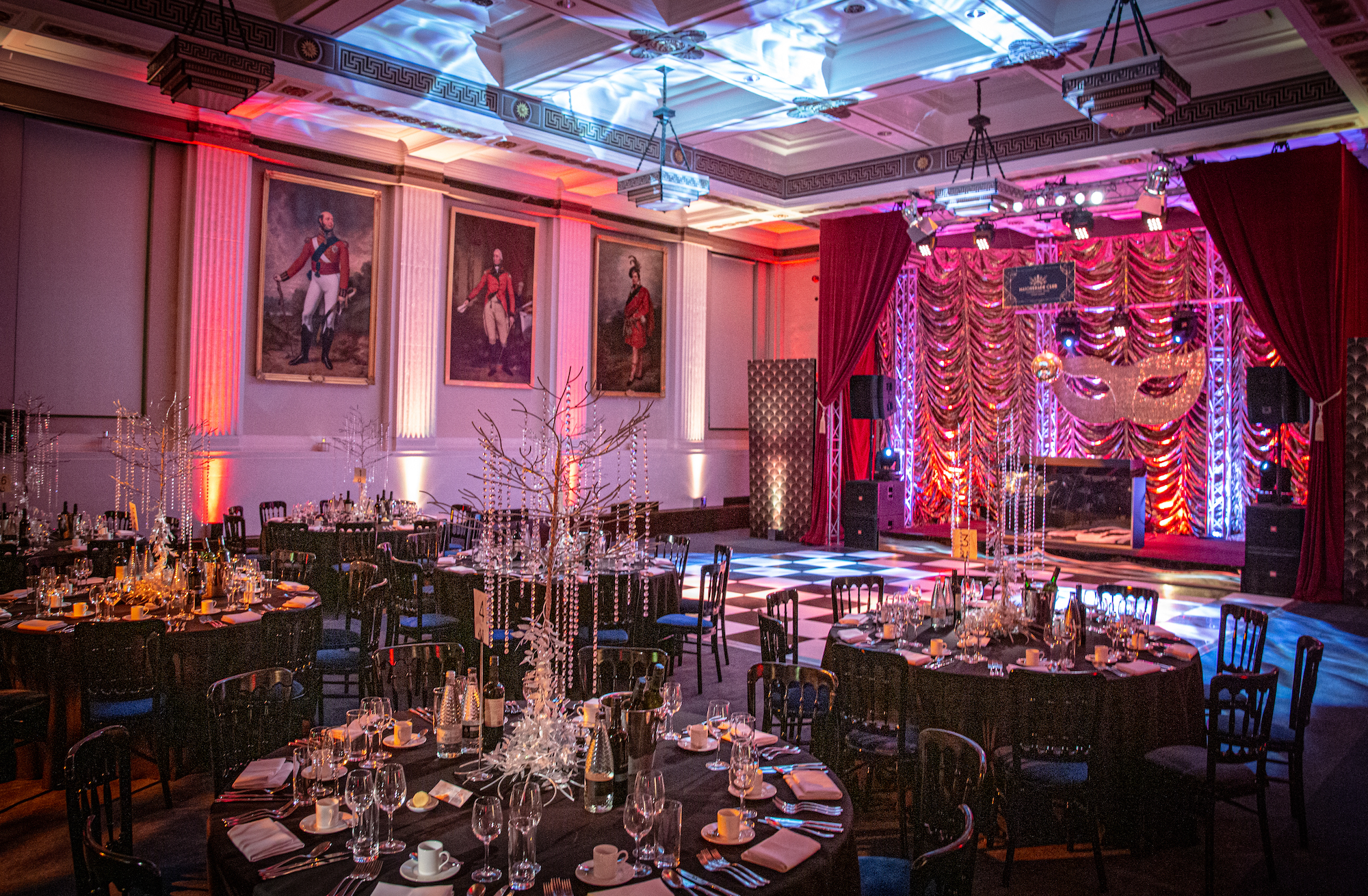 Christmas party setup at Freemasons' Hall with elegant tables and dramatic lighting.