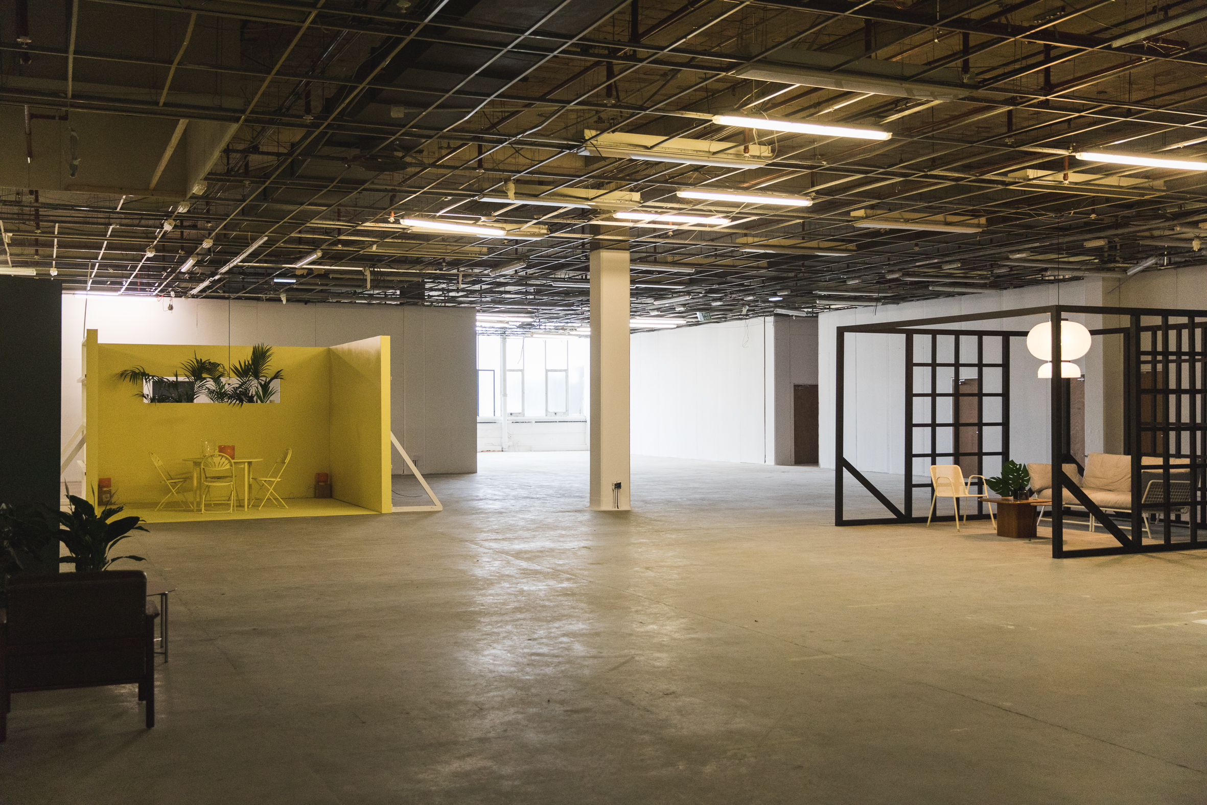 Spacious Main Gallery venue with vibrant yellow corner for networking and events.