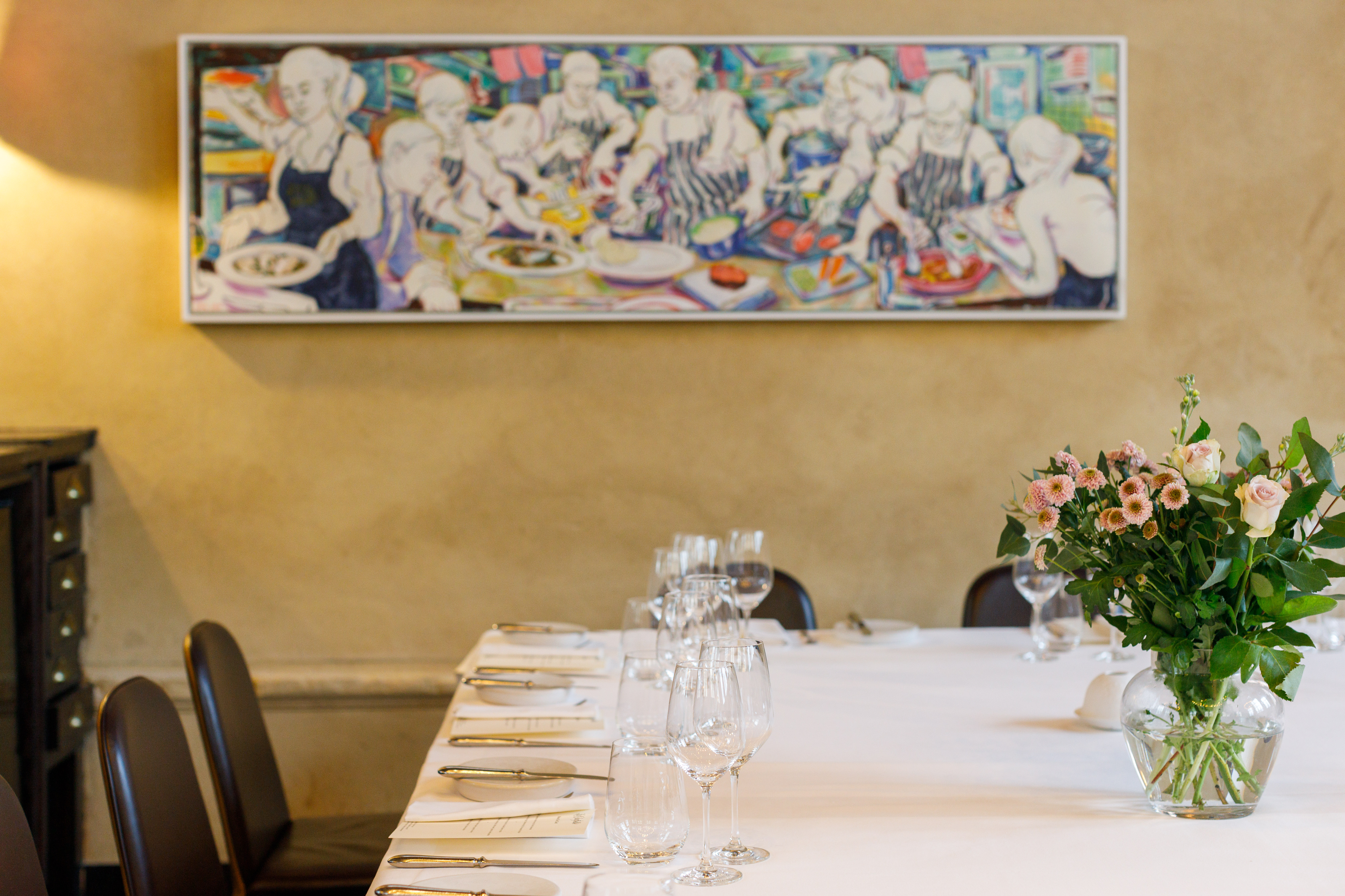 Elegant dining table with floral centerpiece for intimate gatherings or corporate dinners.