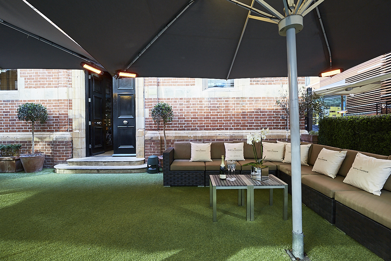 Stylish outdoor lounge at Le Jardin, perfect for networking events and casual meetings.
