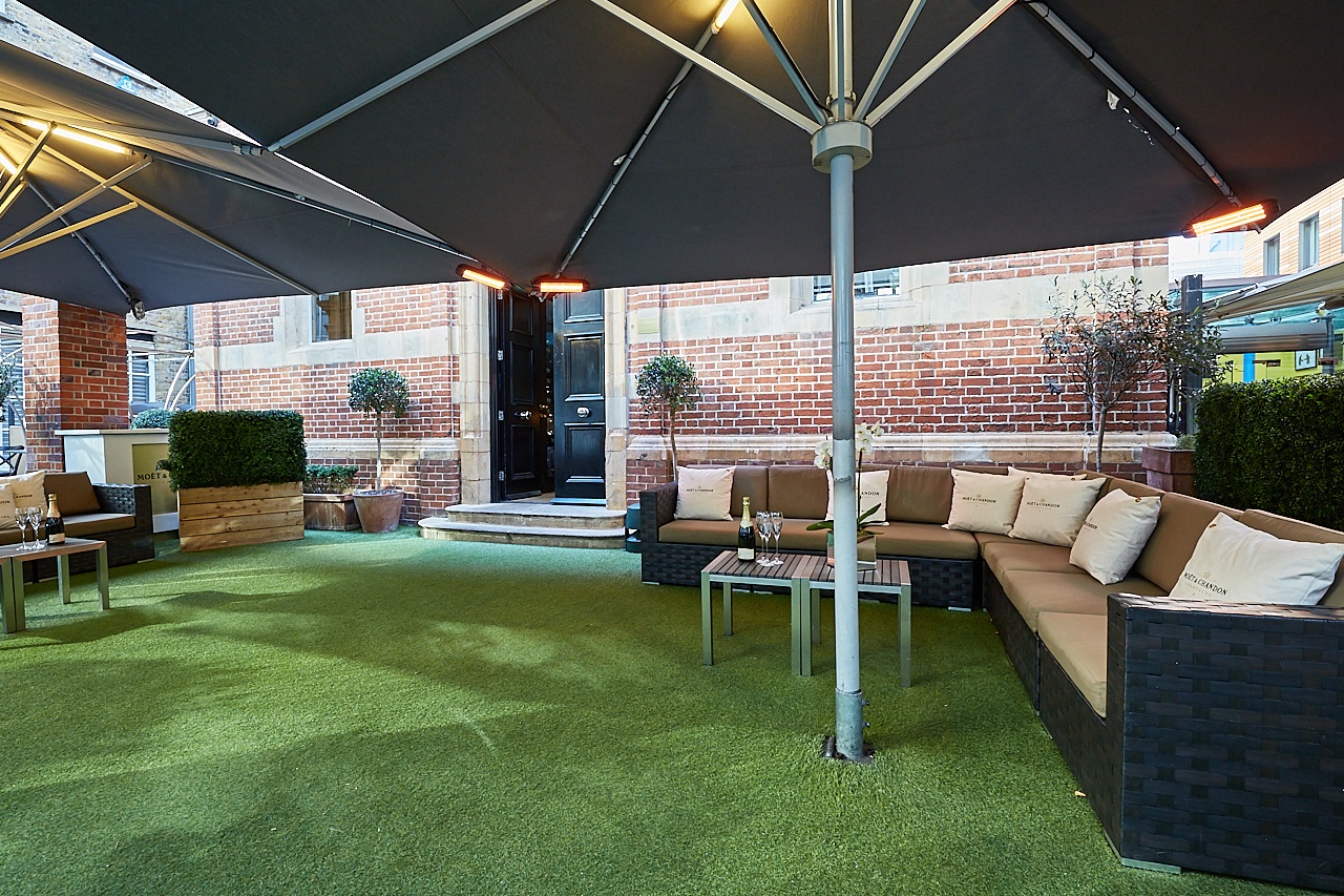 Stylish outdoor lounge at Le Jardin, perfect for networking events and casual meetings.