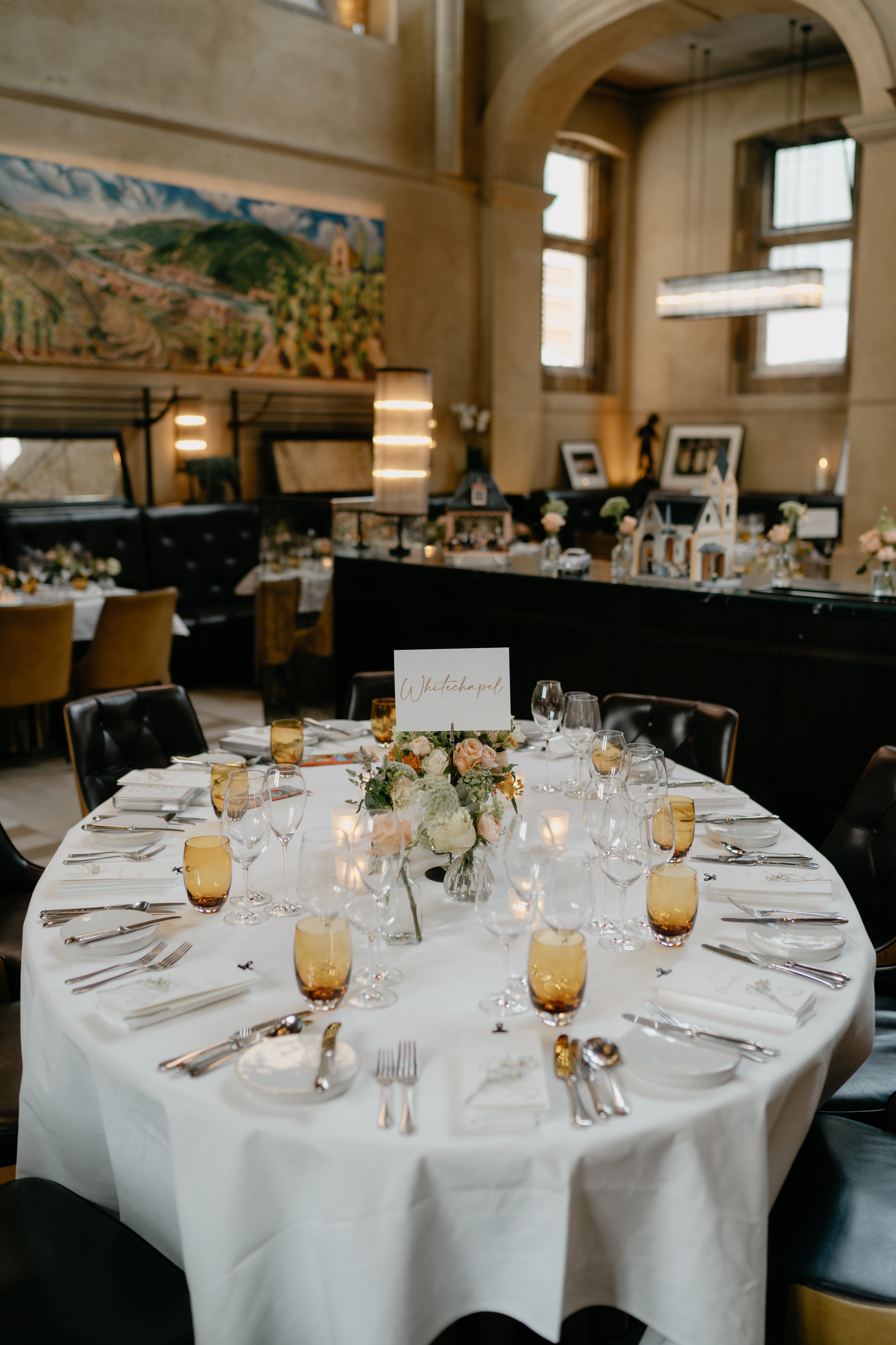 Elegant dining table setup with floral centerpieces for weddings and upscale events.