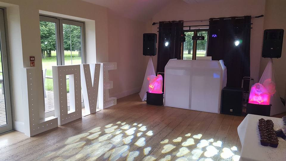 Terrace Suite at Hampton Court Palace Golf Club with illuminated "LOVE" sign for weddings.