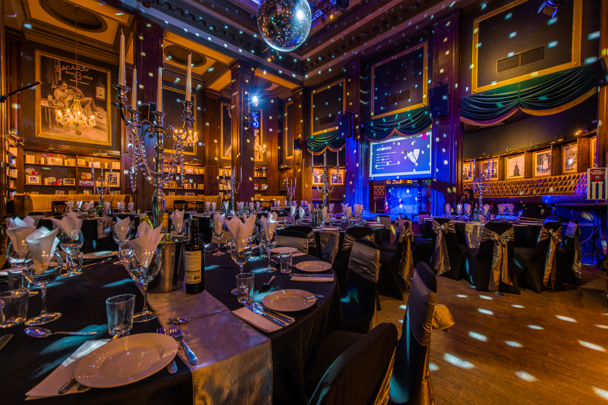 Elegant event space at Havana Bar, featuring black and silver table settings for galas.
