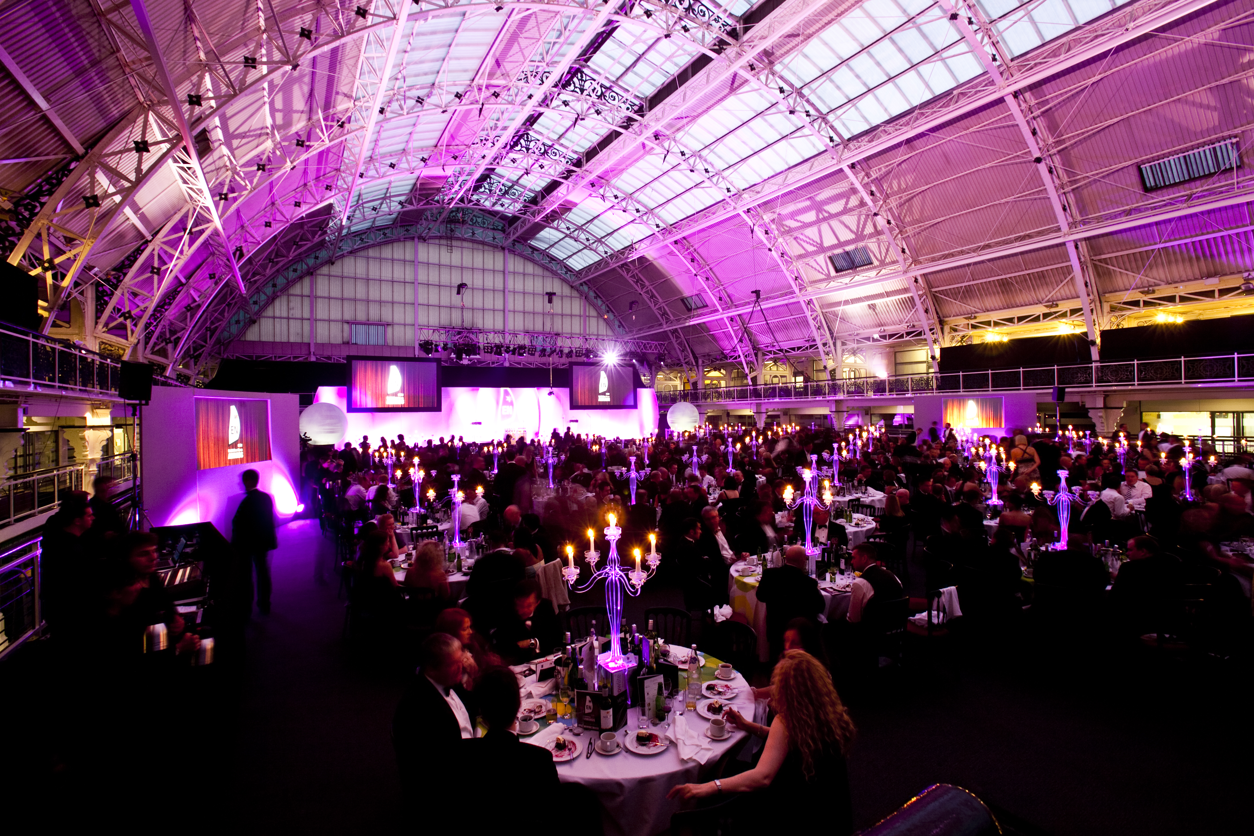 Vibrant Mezzanine event space with elegant tables and purple lighting for formal gatherings.
