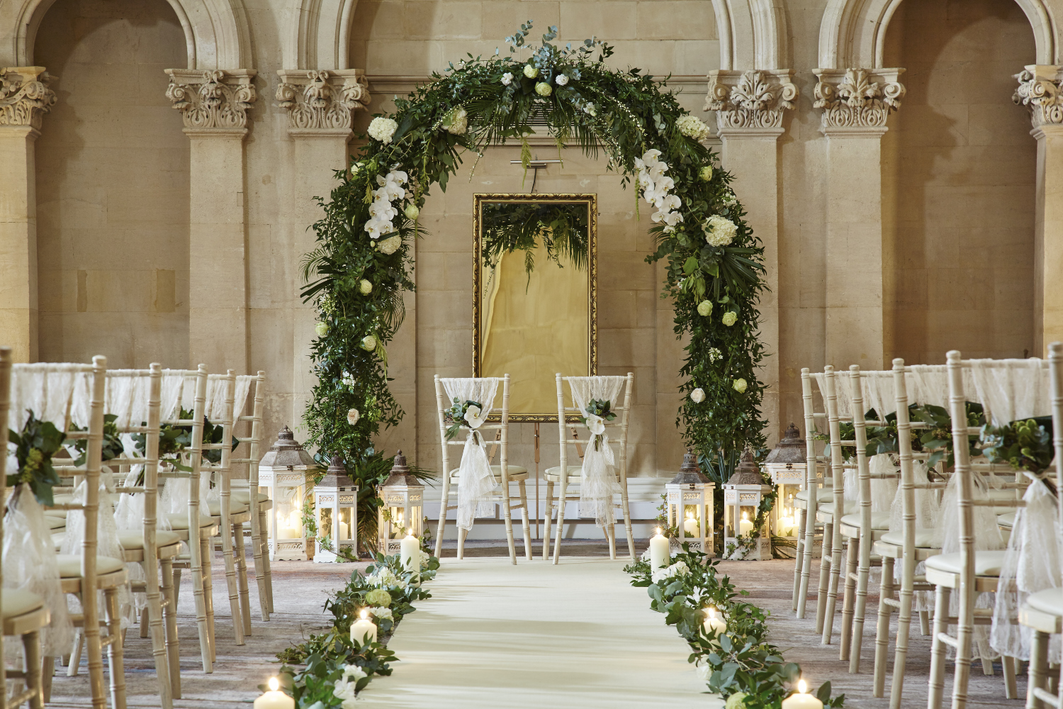 Elegant wedding ceremony setup with floral arch at Bristol Marriott Royal Hotel, Palm Court.