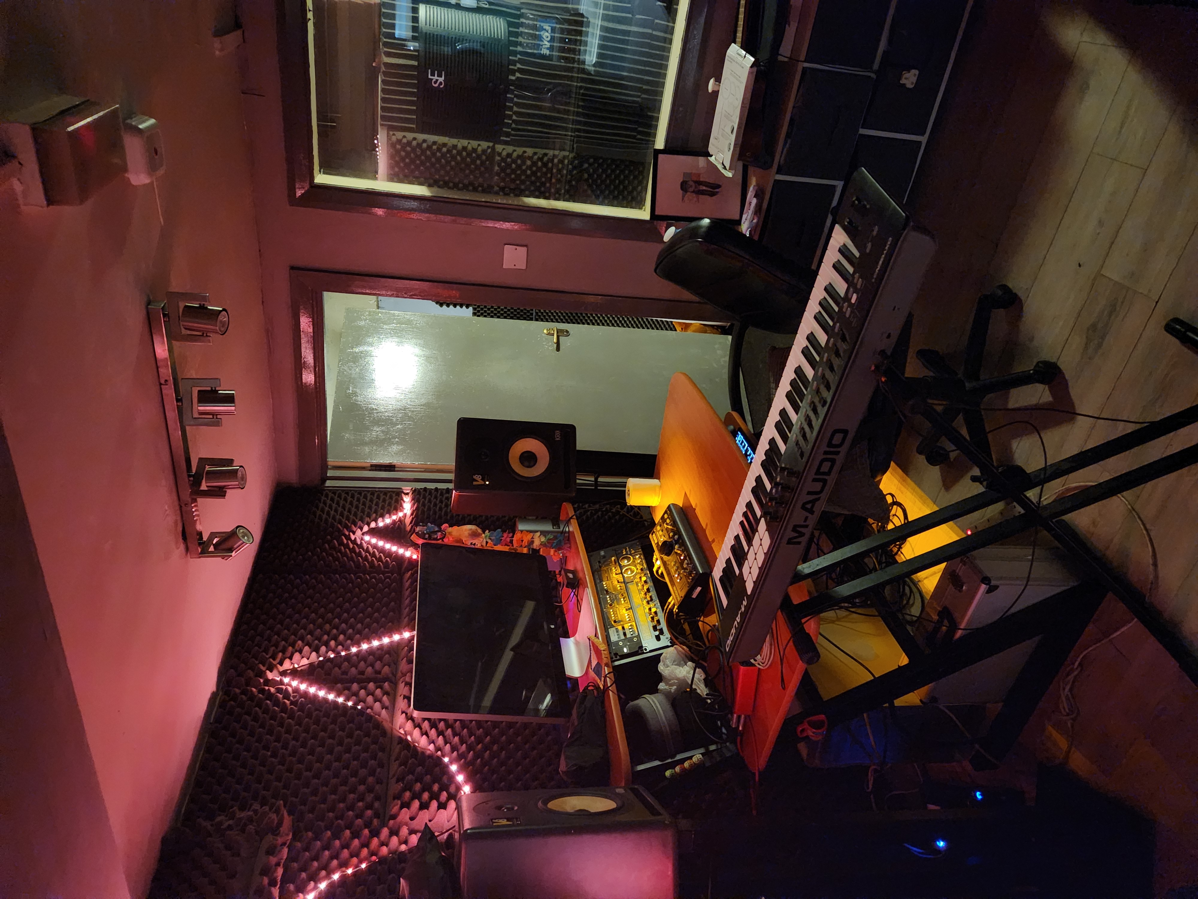 Recording studio with keyboard and soundproofing for creative workshops and events.