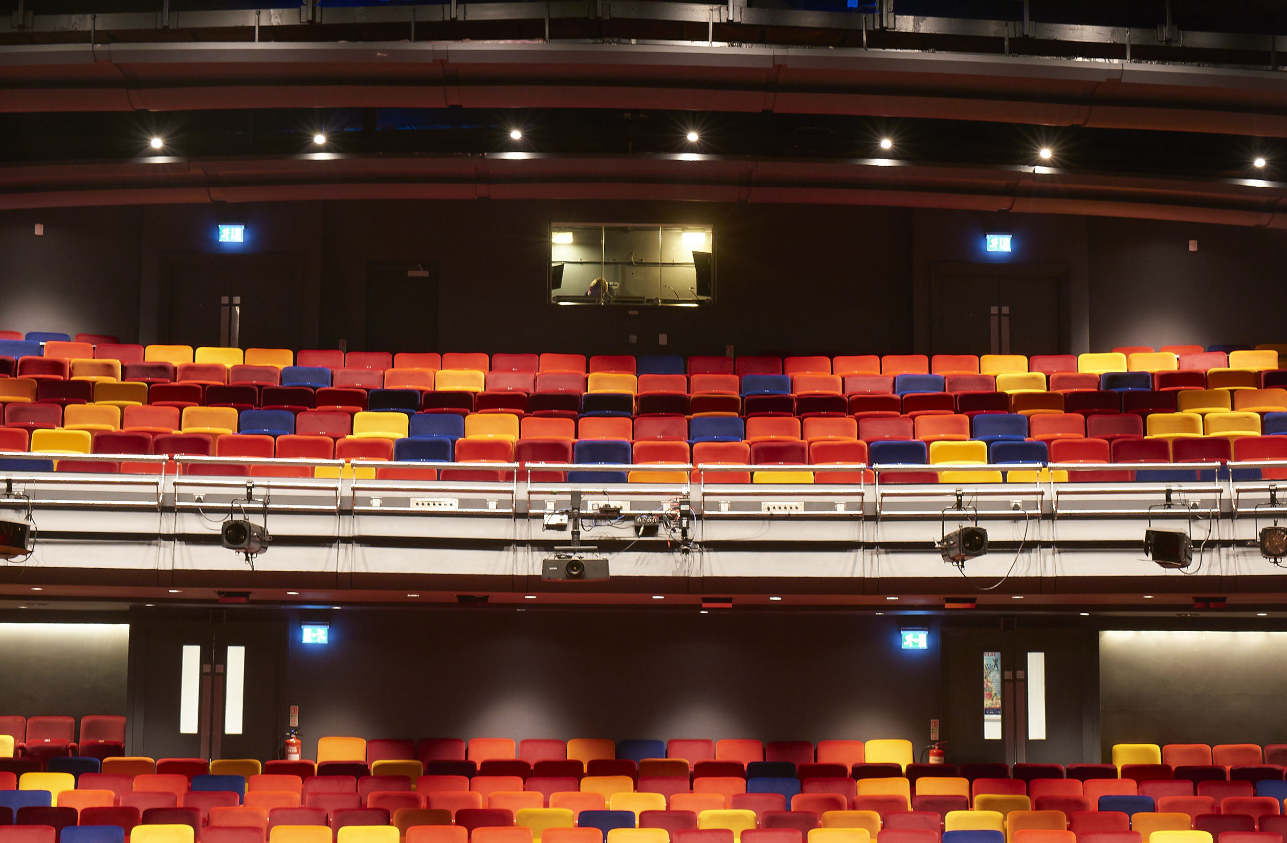 Main Stage Auditorium at Oxford Playhouse with vibrant tiered seating for performances.