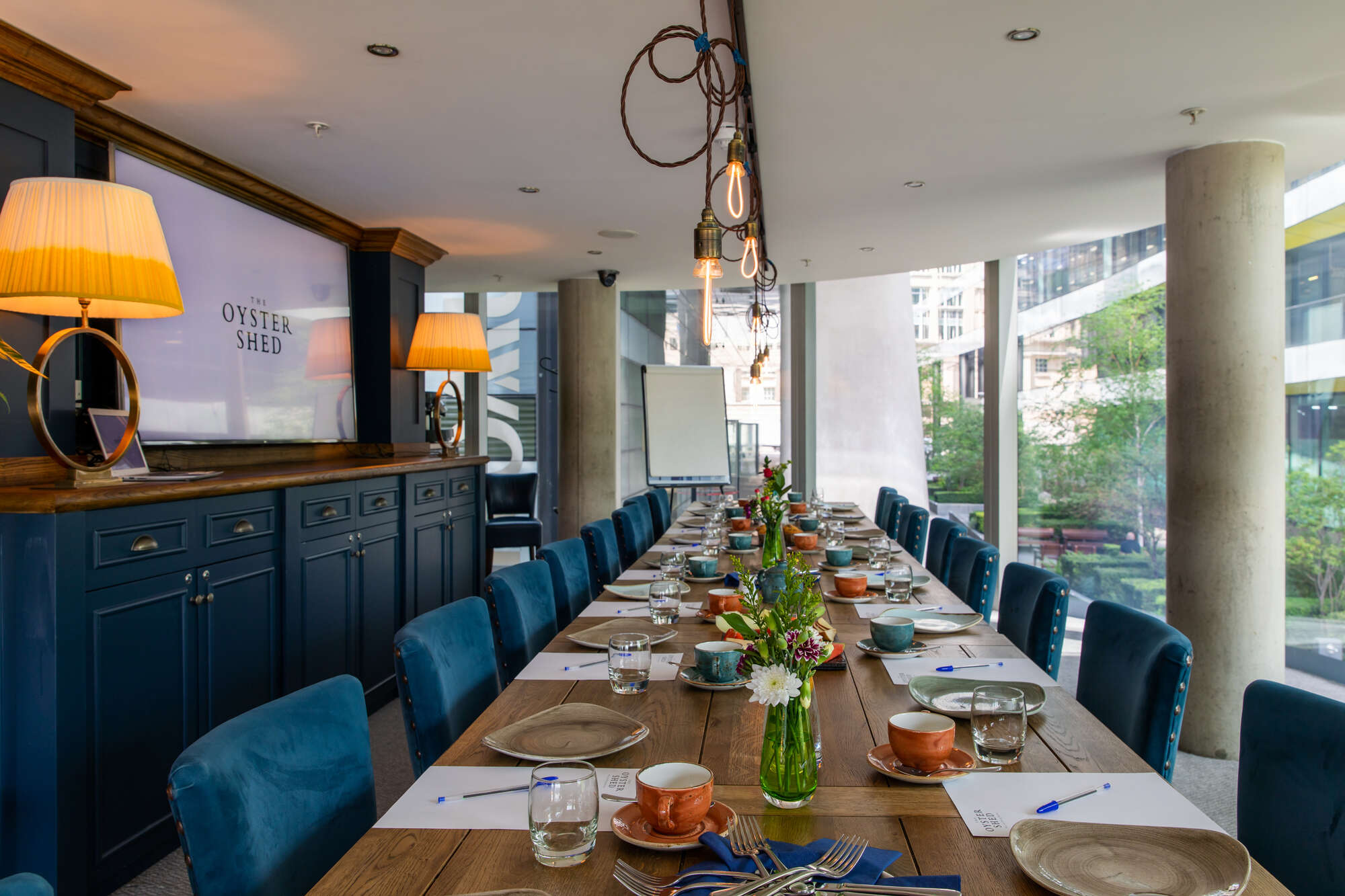Elegant meeting room with wooden table, ideal for gatherings and brainstorming events.