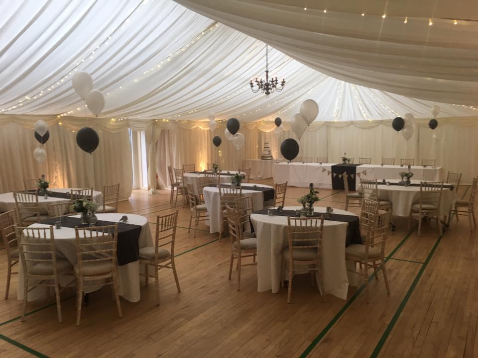 Elegant event space at Gamlingay Eco Hub with round tables and sophisticated decor.