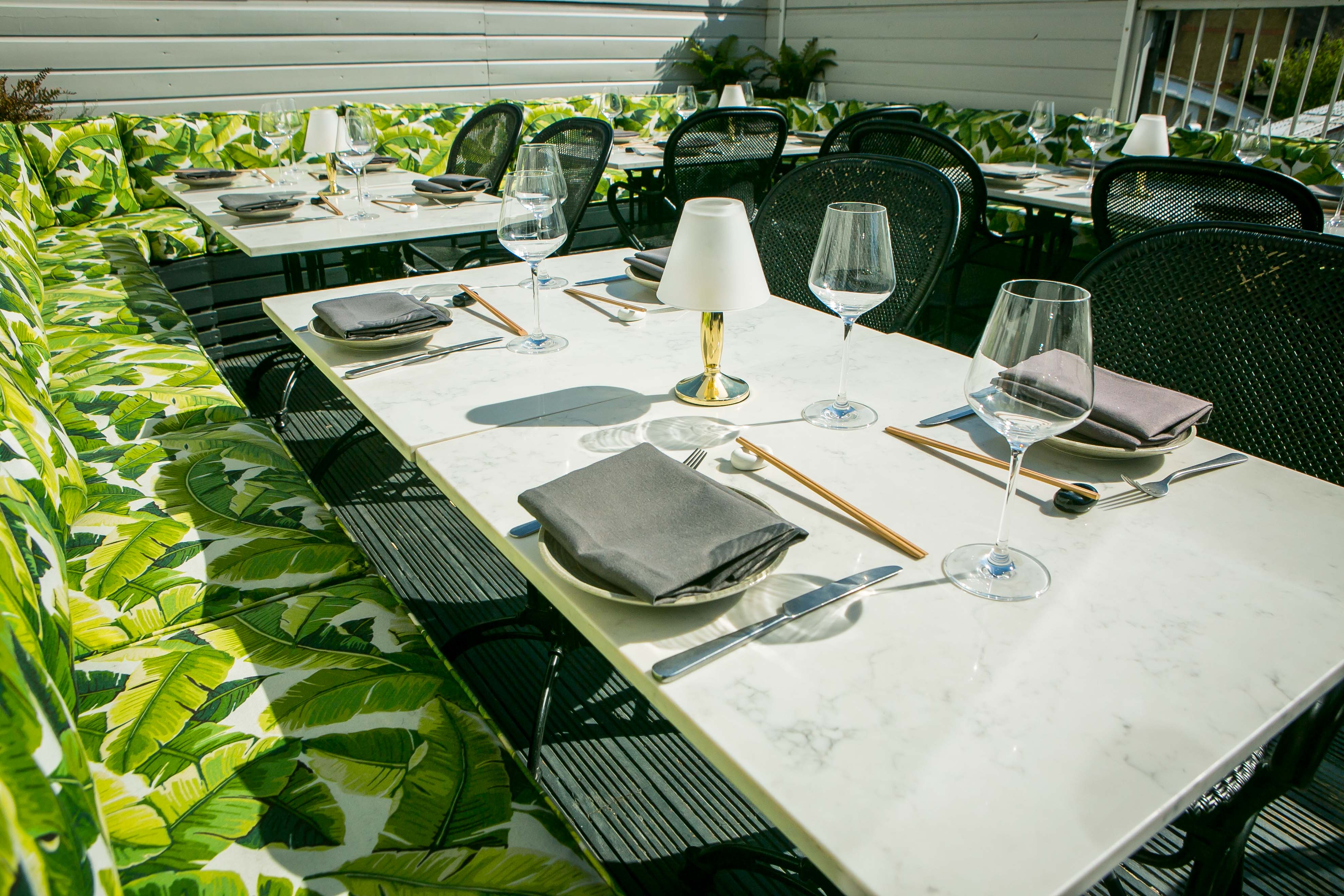 Al Fresco Terrace dining setup with marble tables, ideal for outdoor events and gatherings.