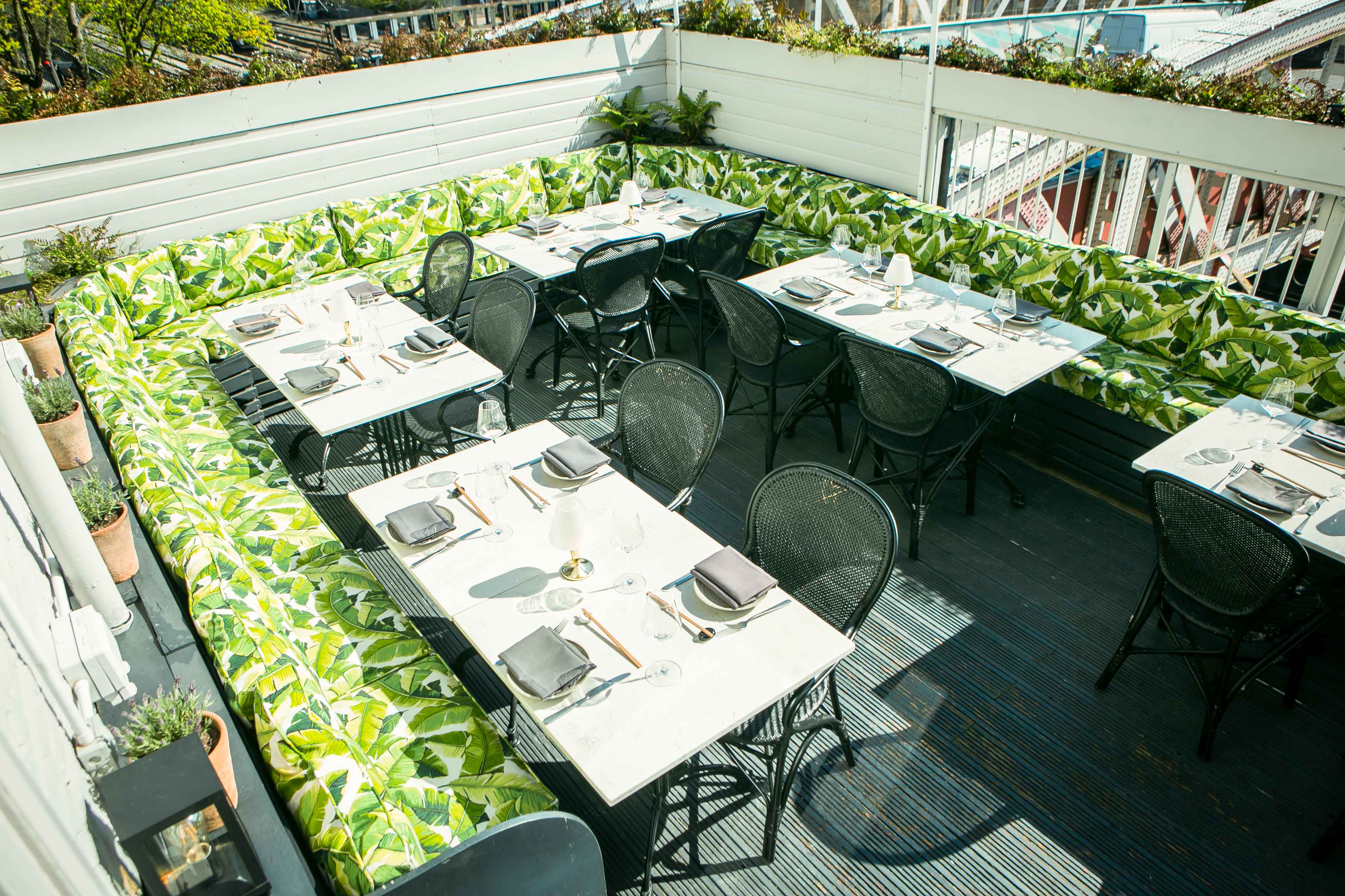 Stylish outdoor dining area with vibrant green seating for gatherings and events.