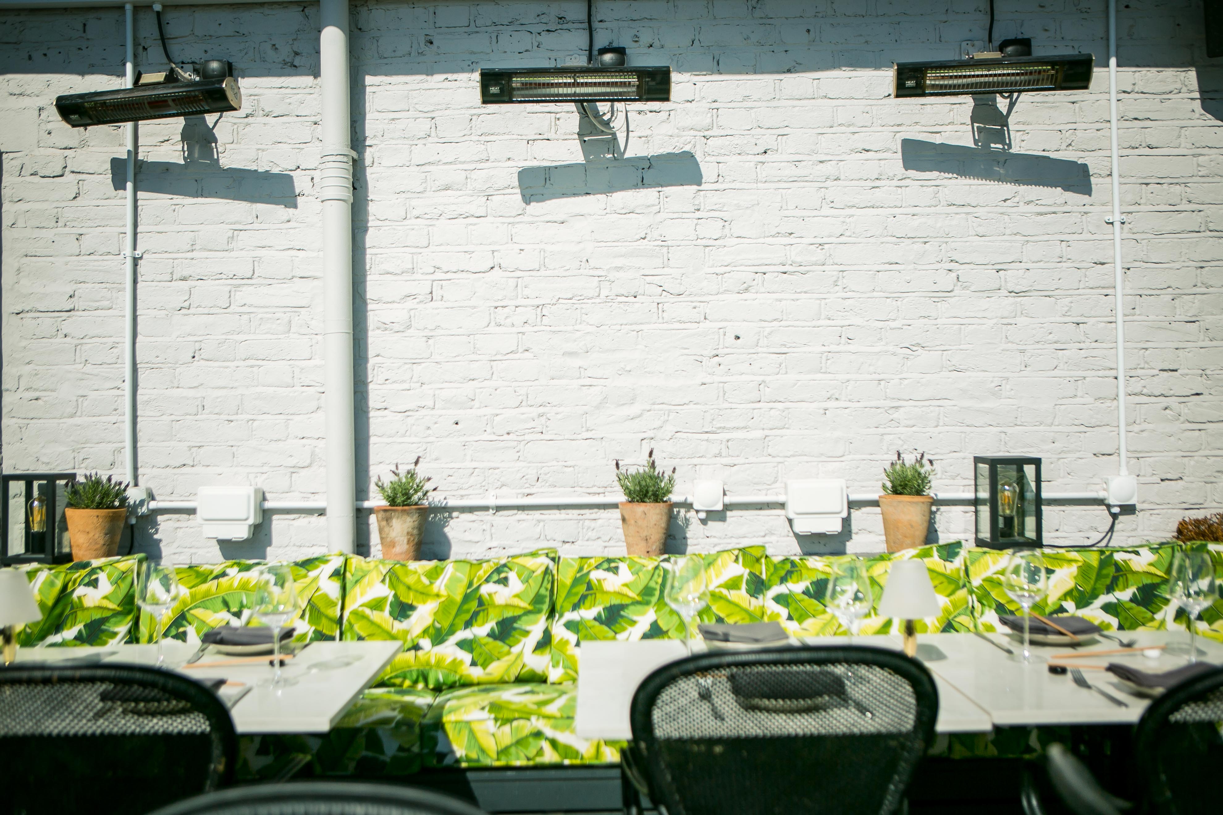 Al Fresco Terrace outdoor dining space with lush decor, ideal for casual events and meetings.