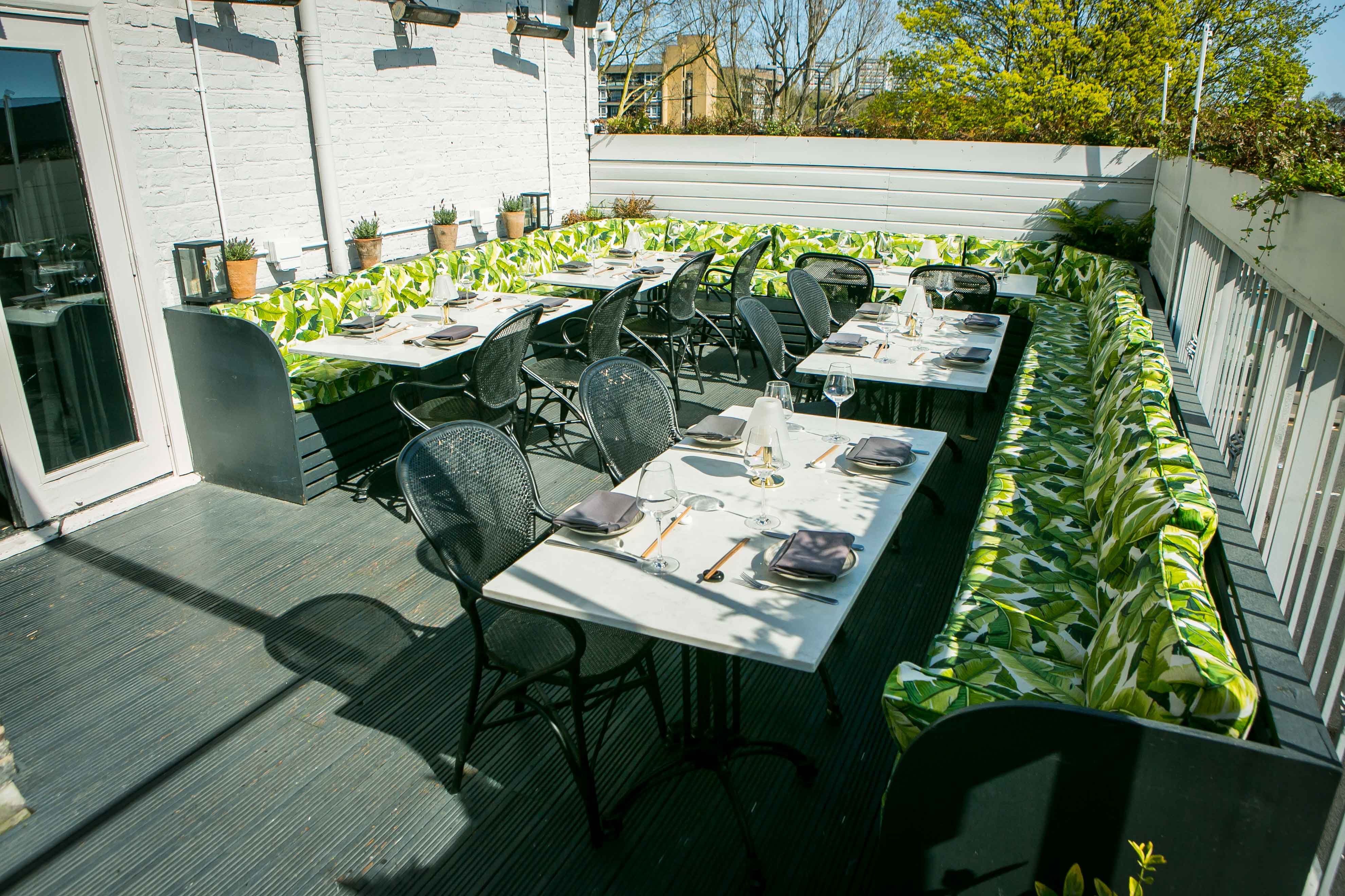 Vibrant outdoor dining area at Al Fresco Terrace, perfect for networking events and gatherings.