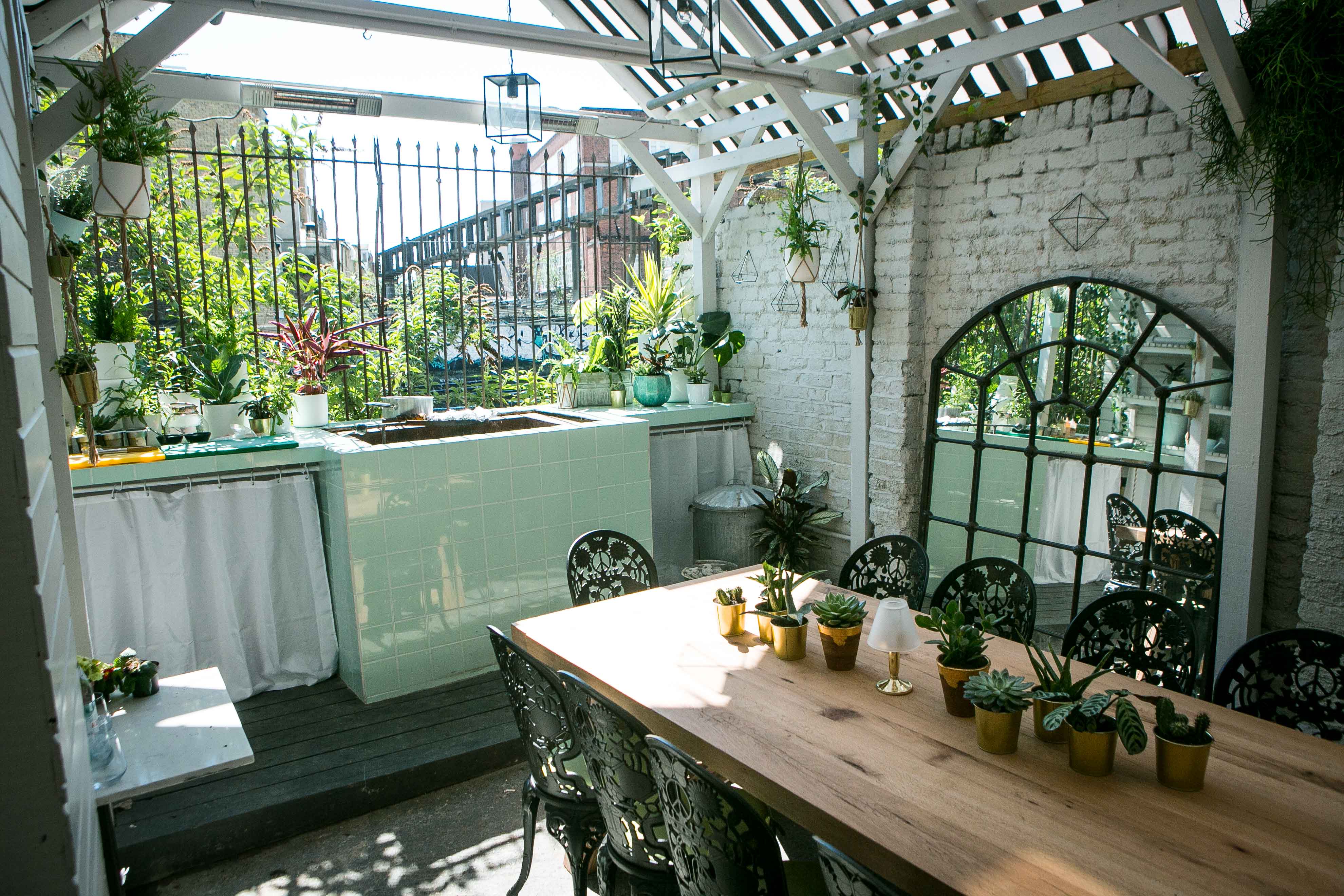 Al Fresco BBQ Garden with wooden table, ideal for gatherings and workshops in Southam Street.