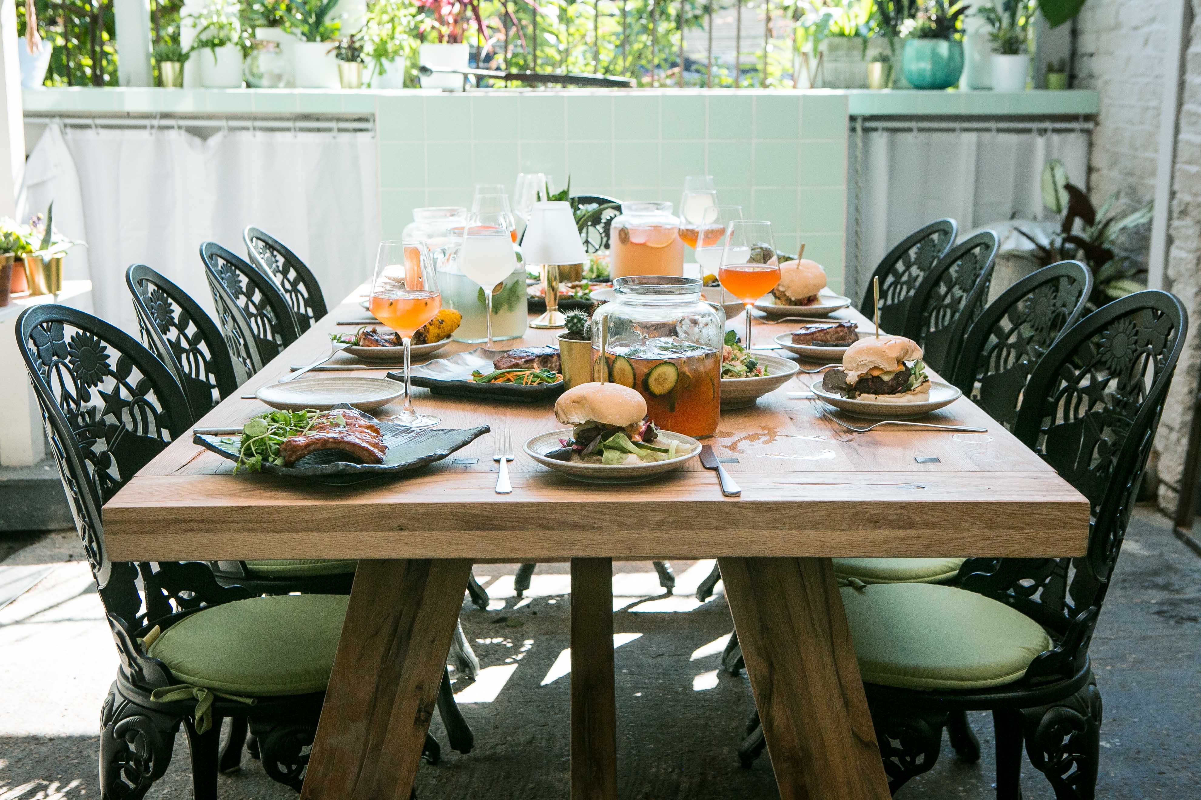 Al Fresco BBQ Garden dining setup with gourmet dishes for corporate retreats and gatherings.