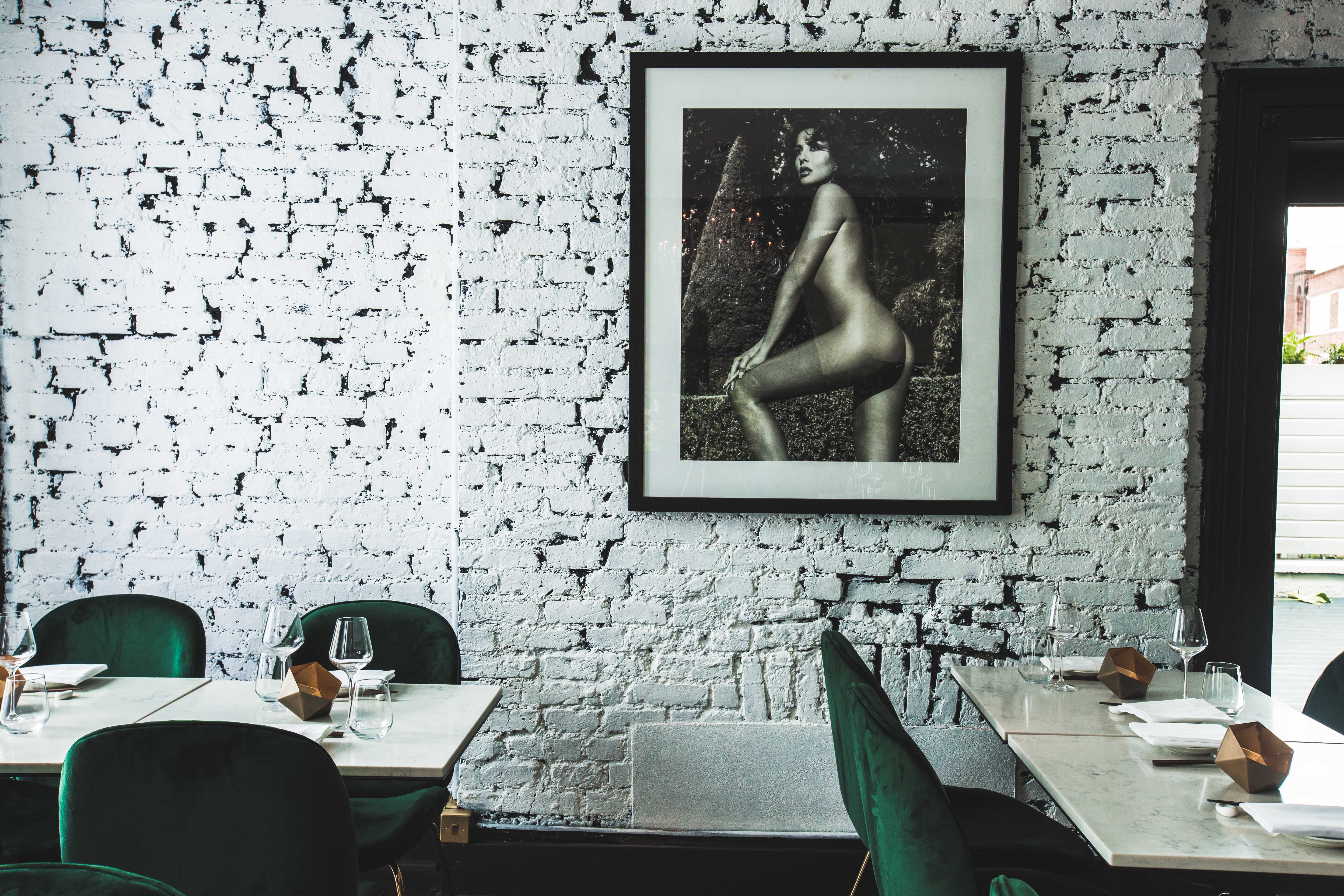 Stylish Robata Grill with exposed brick and green seating, perfect for upscale events.