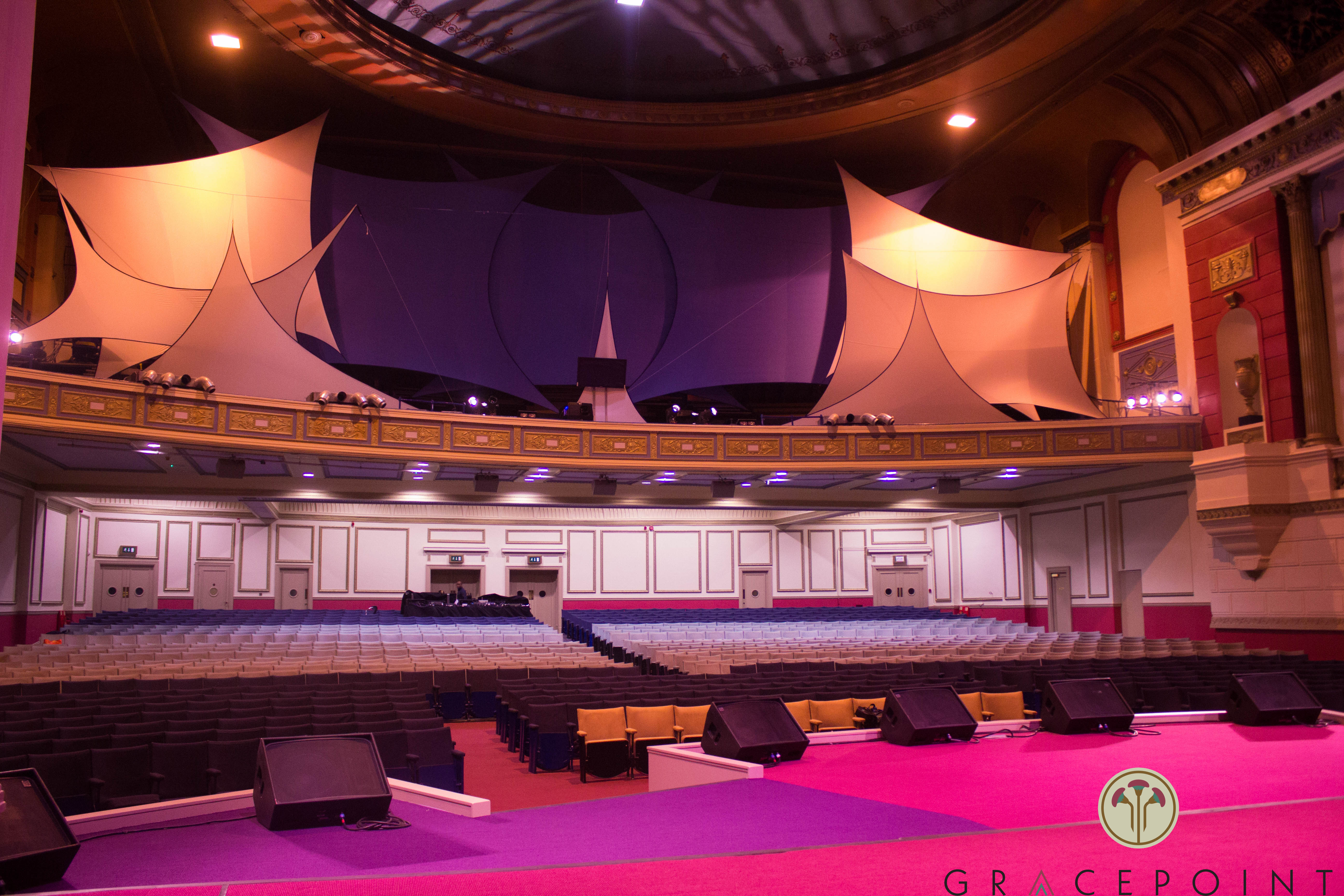 Spacious GRACEPOINT venue with elegant stage, ideal for conferences and performances.