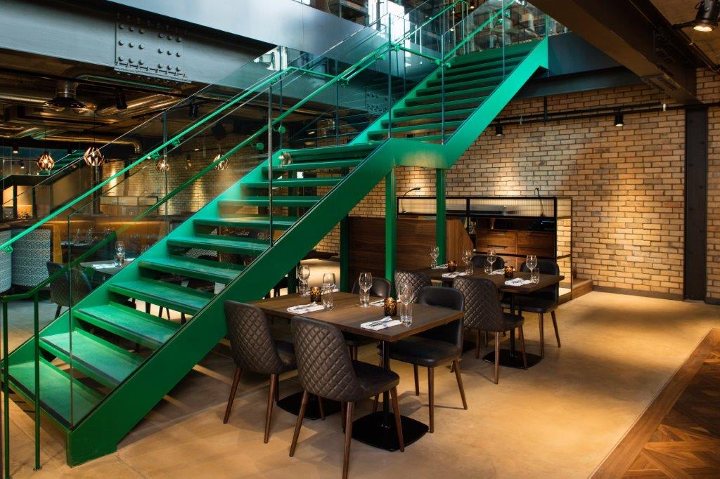 Drake & Morgan Kings Cross dining space with vibrant green staircase, ideal for events.