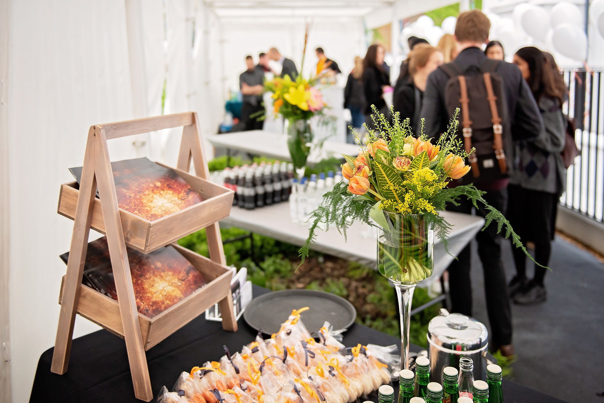 Garden Terrace event setup with stylish refreshment station and vibrant floral arrangements.