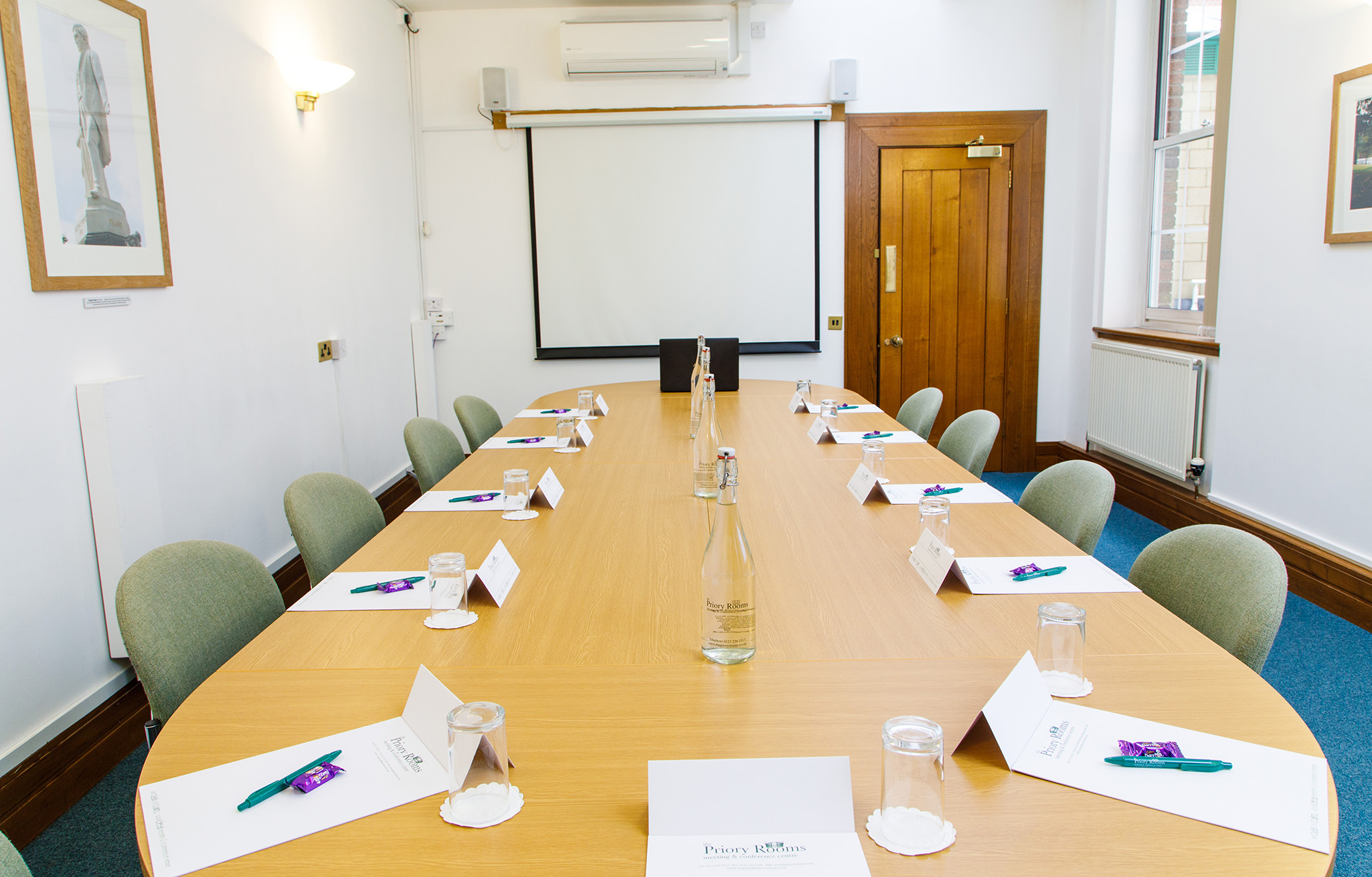 Sturge room at The Priory Rooms, set for professional meetings with a long wooden table.