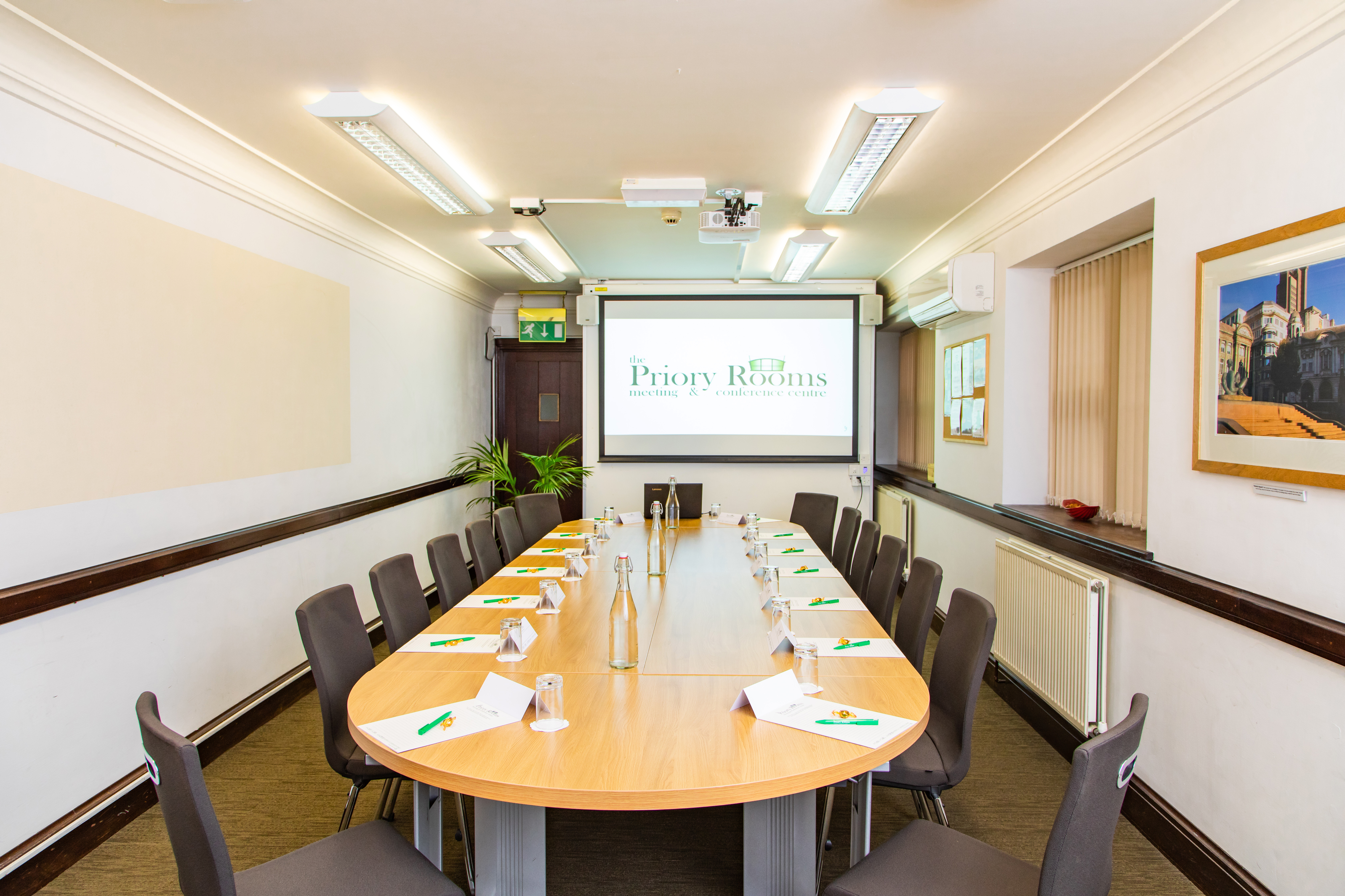 Lloyd room at The Priory Rooms: oval table setup for professional meetings and presentations.