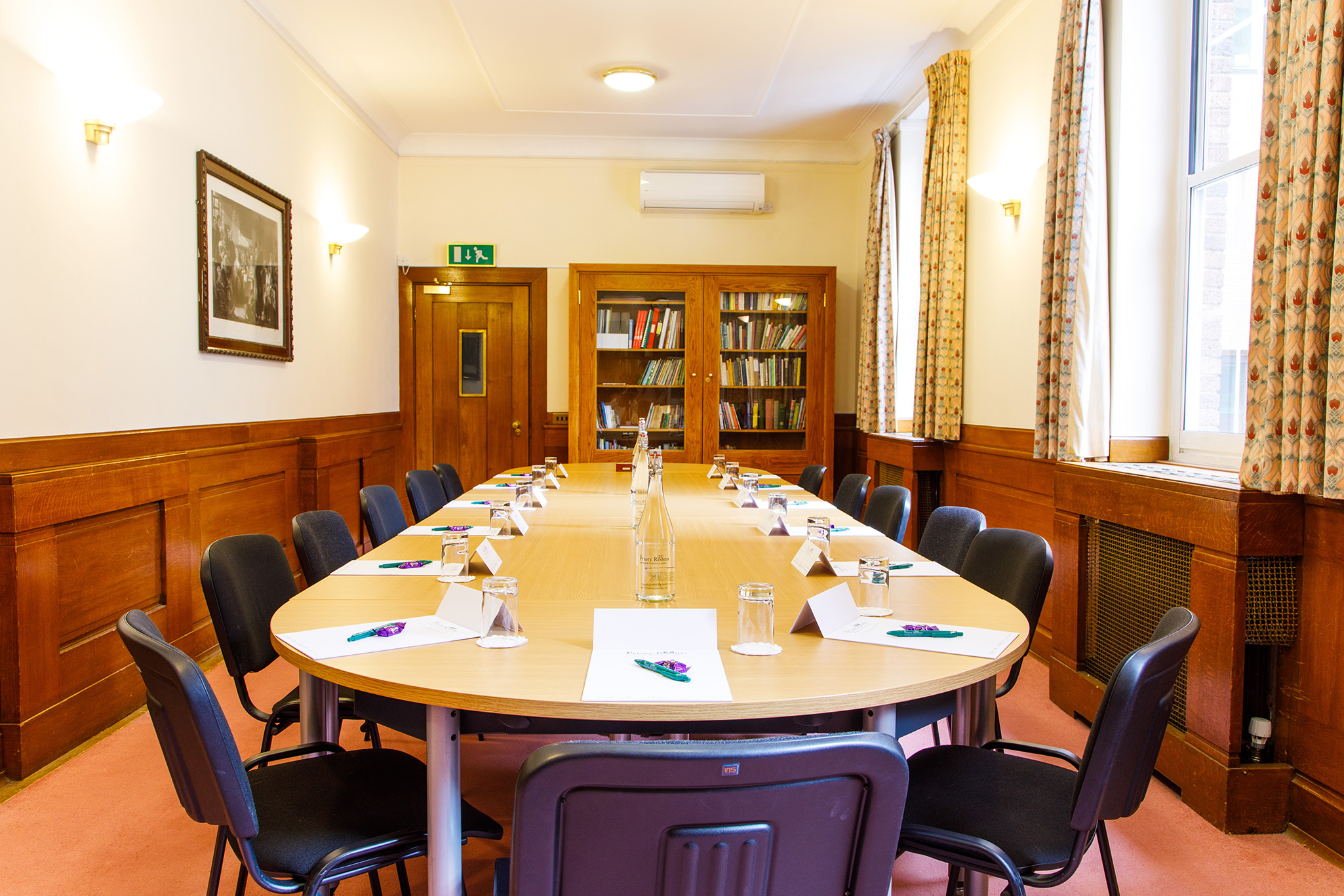 Reading room at The Priory Rooms with round table setup for meetings and conferences.