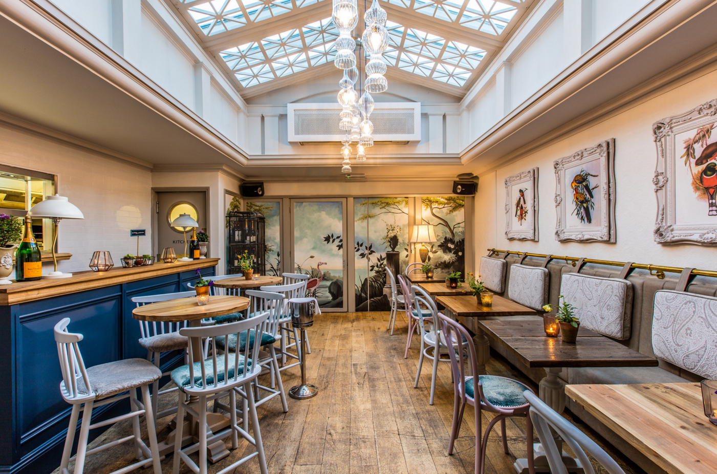 Stylish semi-private aviary venue with skylight for intimate gatherings and events.