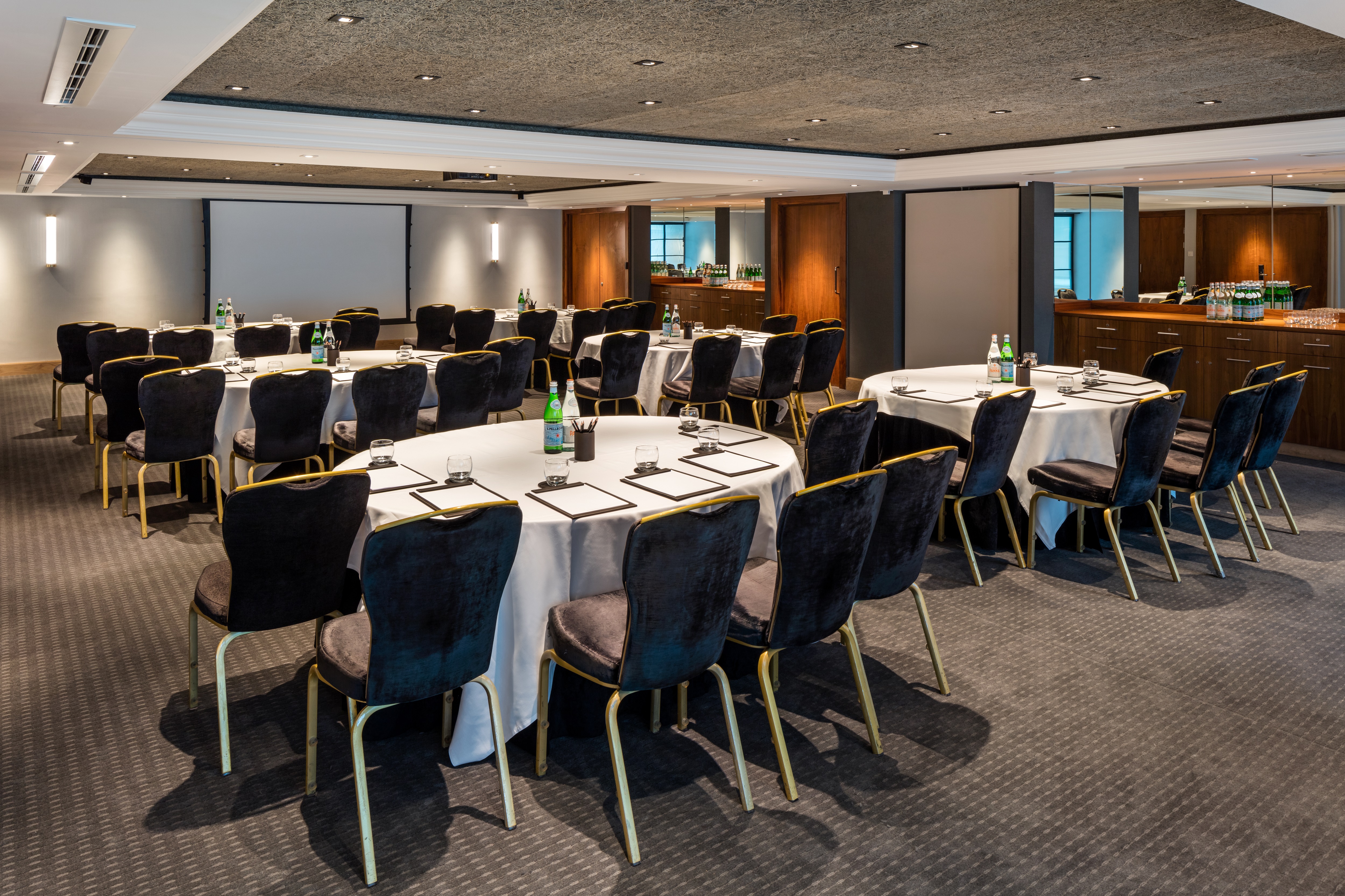Elegant meeting room with round tables for professional events at The Edwardian Manchester.