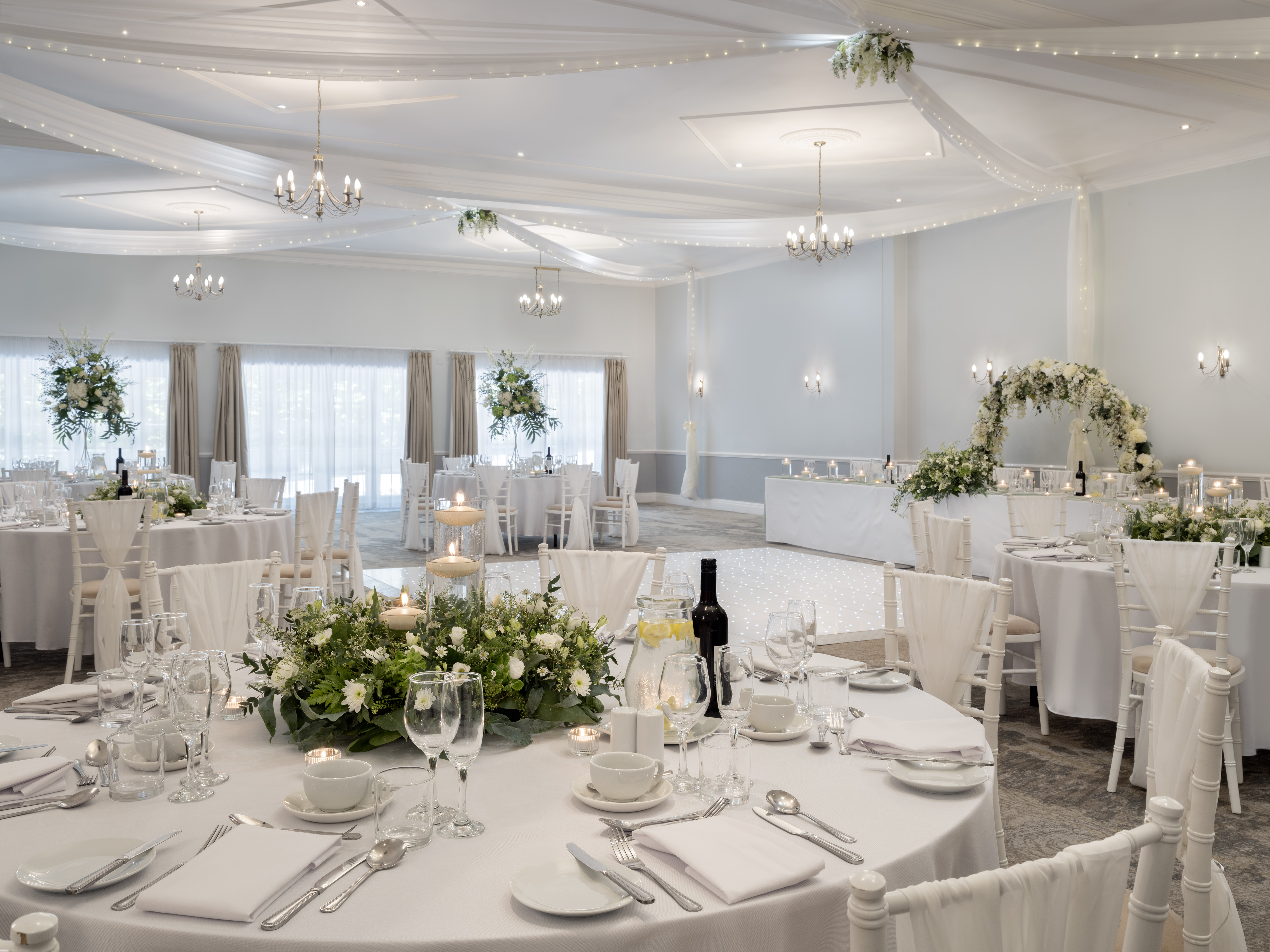 Broughton Suite at Delta Hotels: elegant wedding venue with round tables and floral decor.
