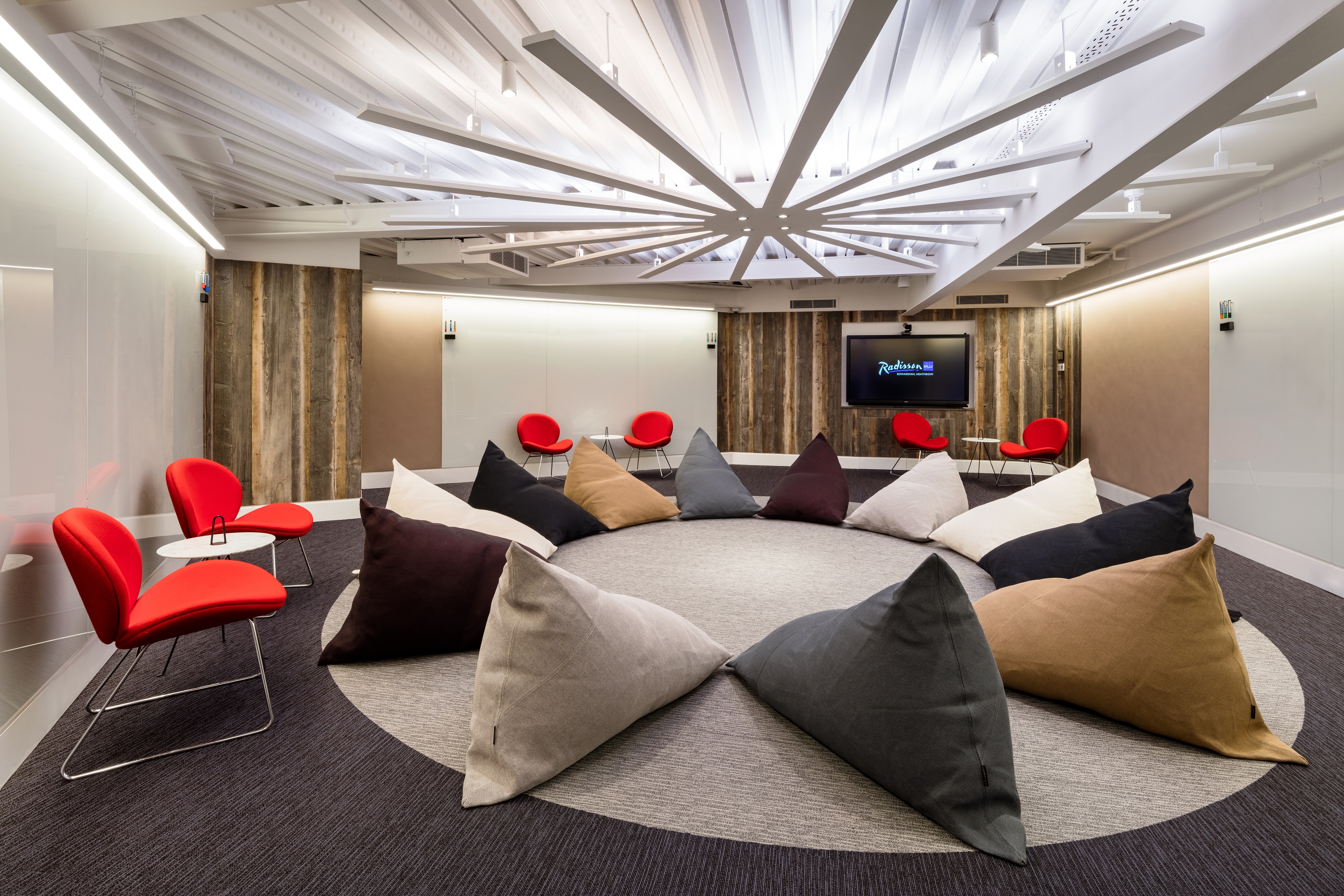 Modern meeting space with circular cushions for creative workshops at Radisson Blu Heathrow.