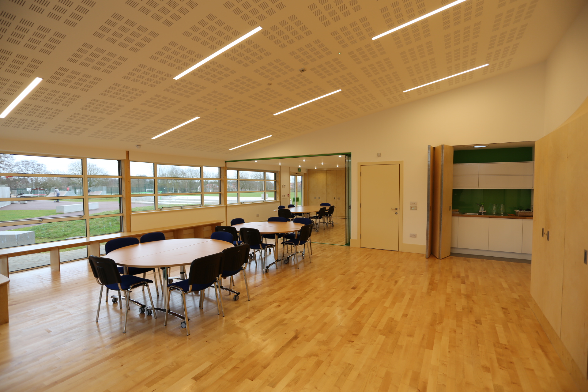 Kier Suite at Gamlingay Eco Hub: modern meeting space with round tables for workshops.