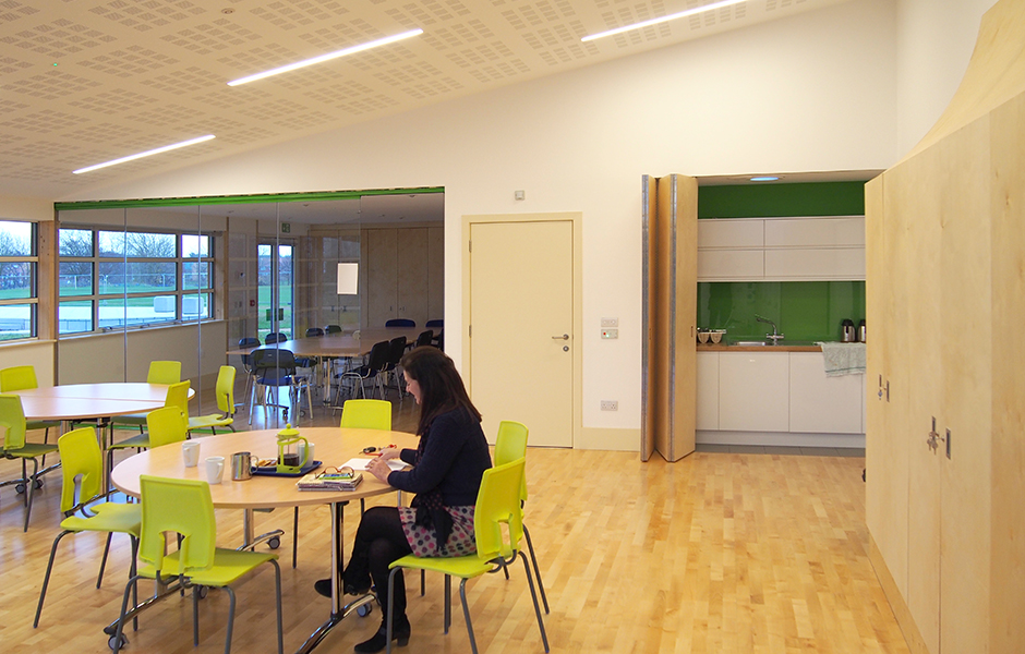 Modern meeting space in Gamlingay Eco Hub with round tables, ideal for workshops.