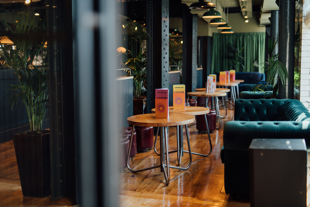 Stylish event space in Revolution York with vibrant signage, ideal for networking gatherings.