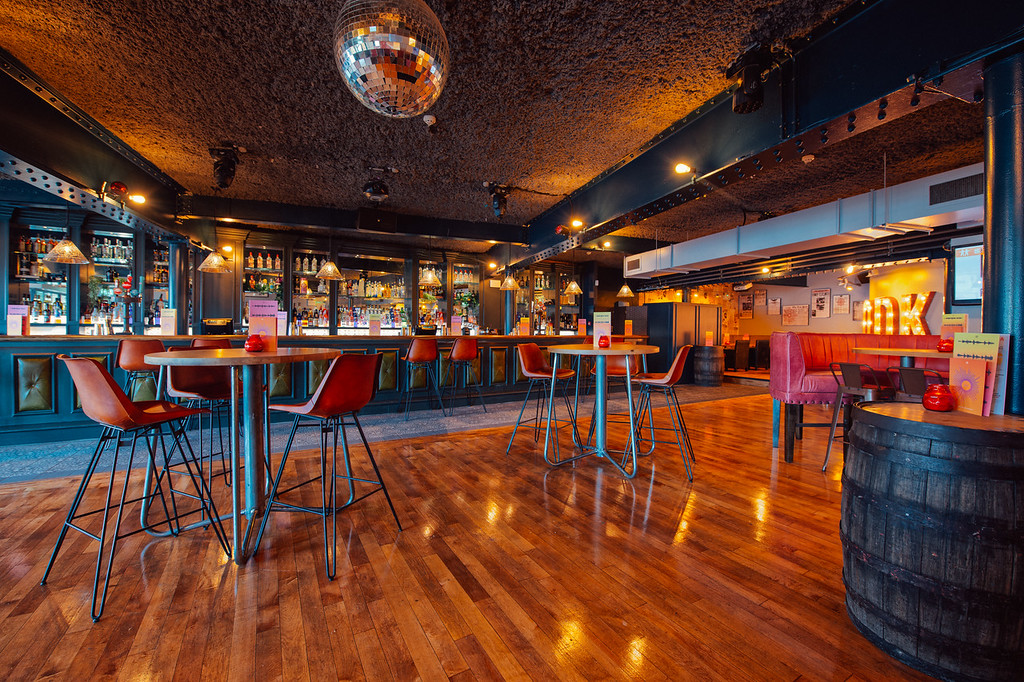 Stylish event space in Revolution York with modern bar, ideal for networking and gatherings.