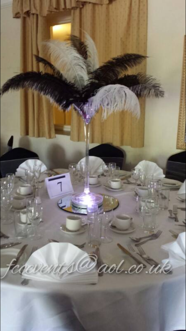 Elegant Belmont Suite table setting with feather centerpiece for formal events.