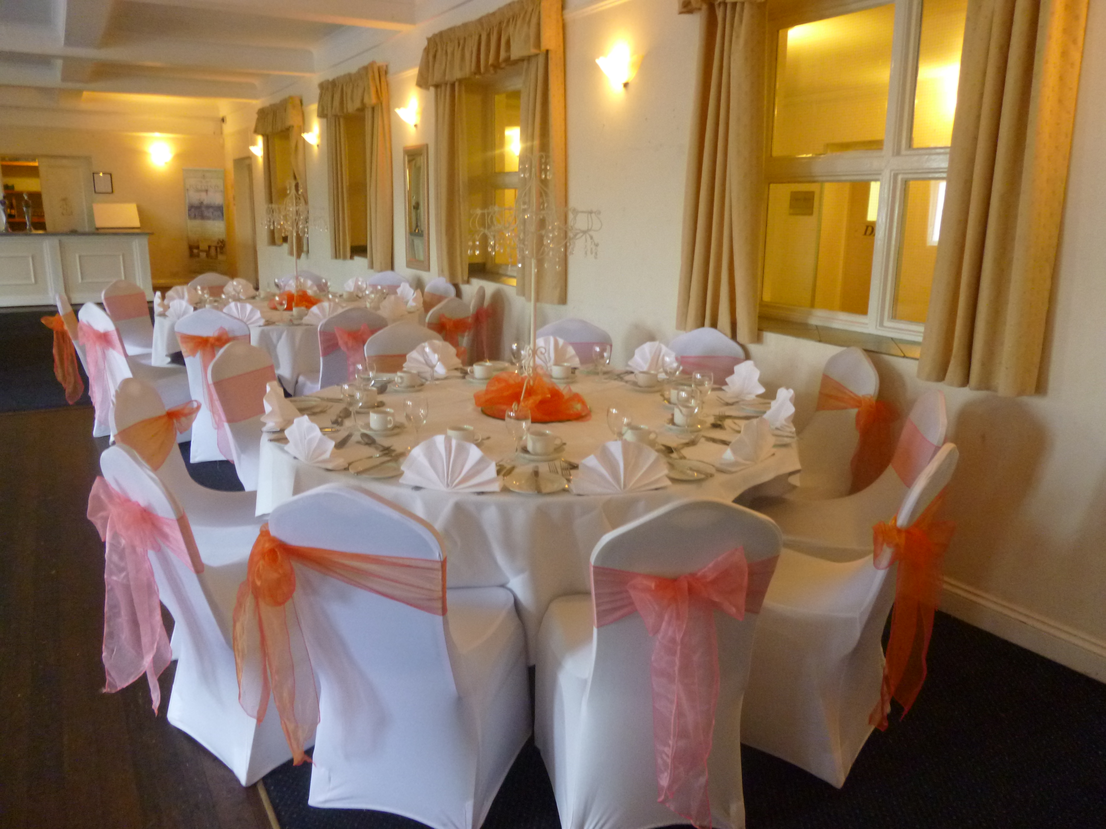 Belmont Suite banquet table with orange accents, ideal for weddings and corporate events.