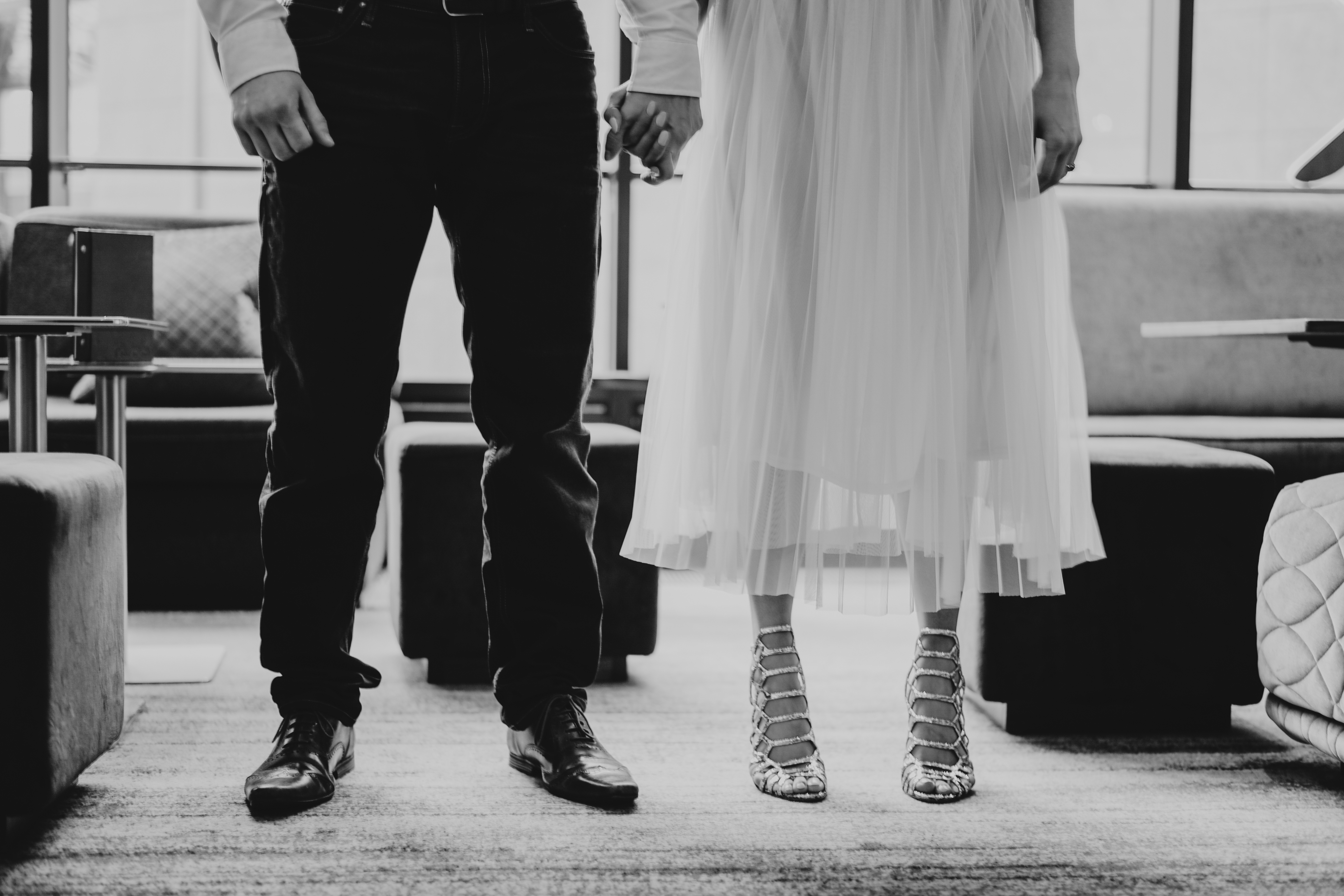 Couple holding hands at TwoRuba Bar, Hilton London Tower Bridge, perfect for weddings and events.