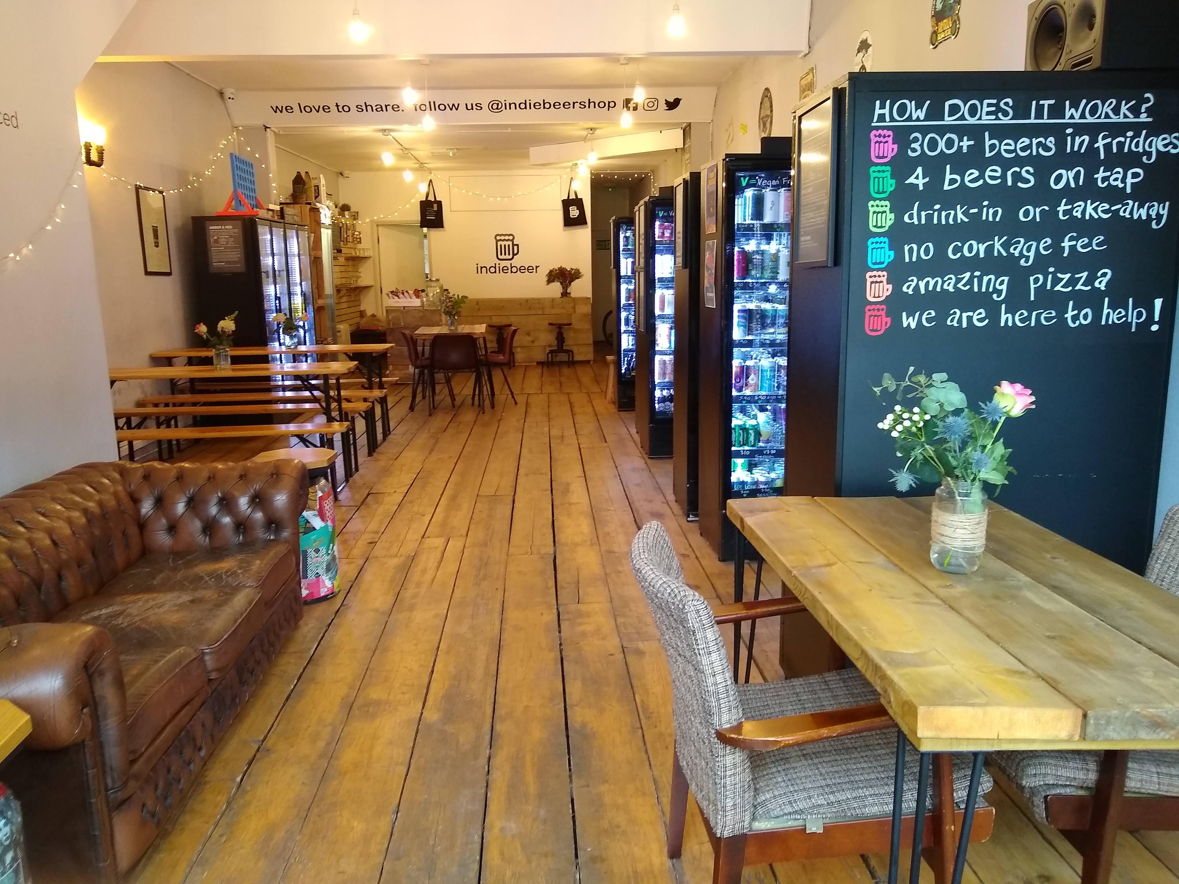 Cozy Indiebeer venue with wooden floors, ideal for casual meetings and networking events.