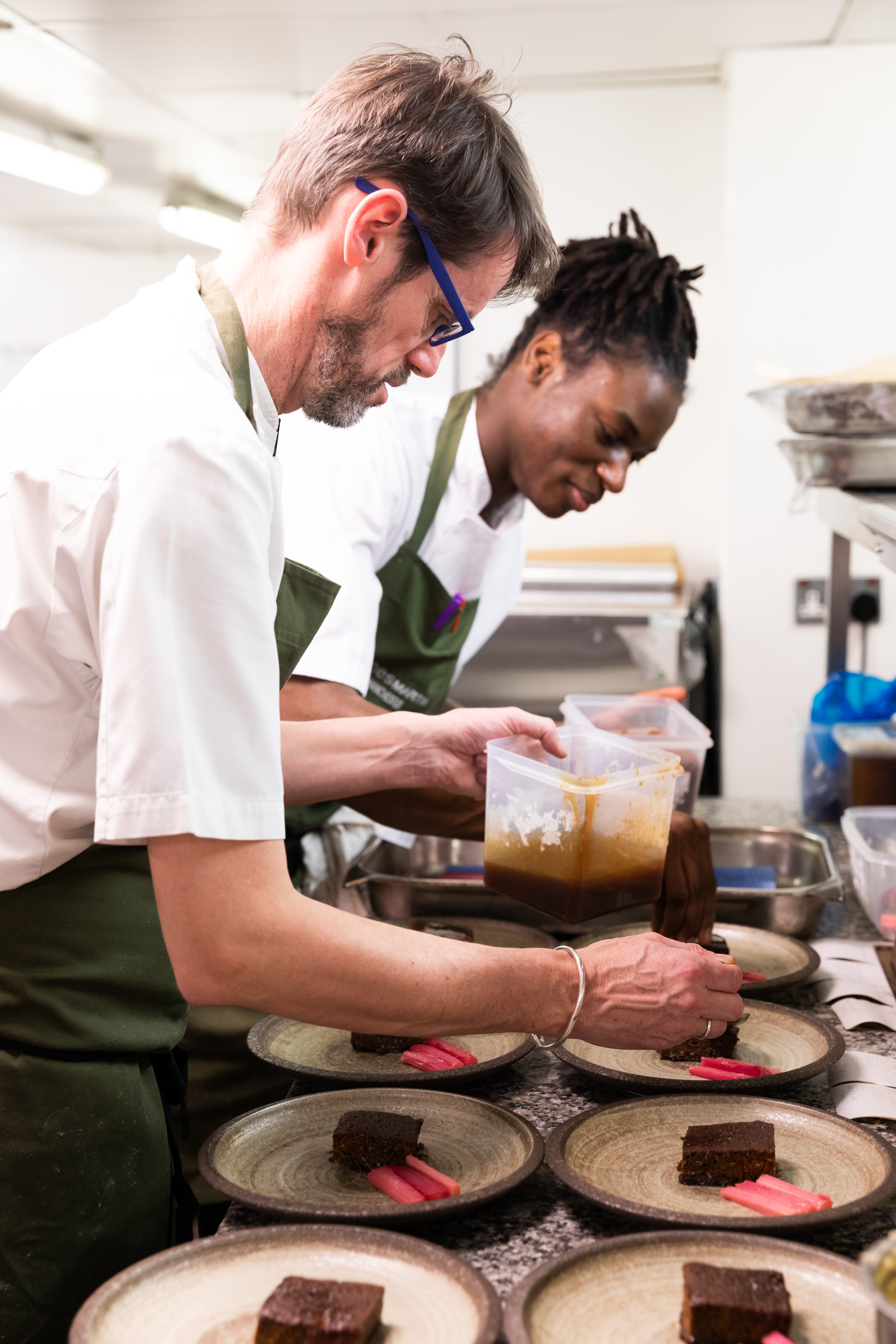 Culinary teamwork at James Martin restaurant in Manchester, preparing for a catering event.
